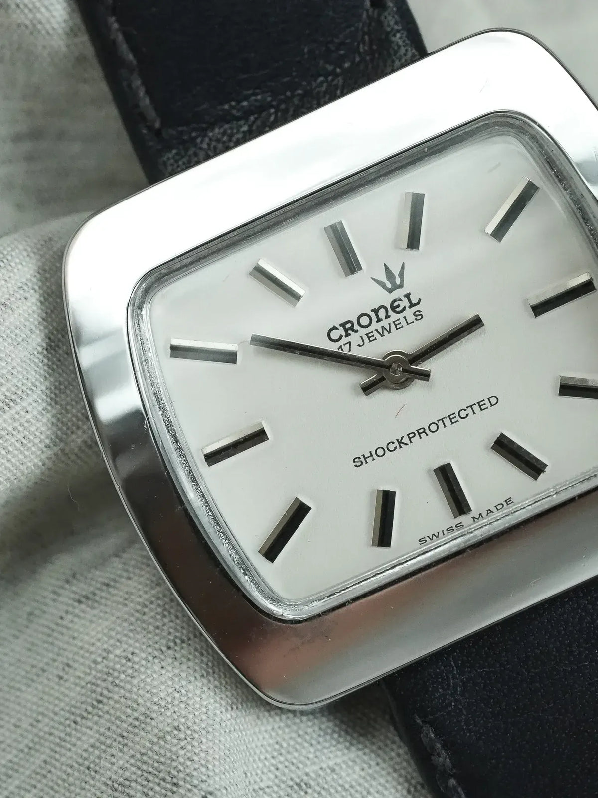 Cronel vintage watch with white dial, steel case, and black leather strap