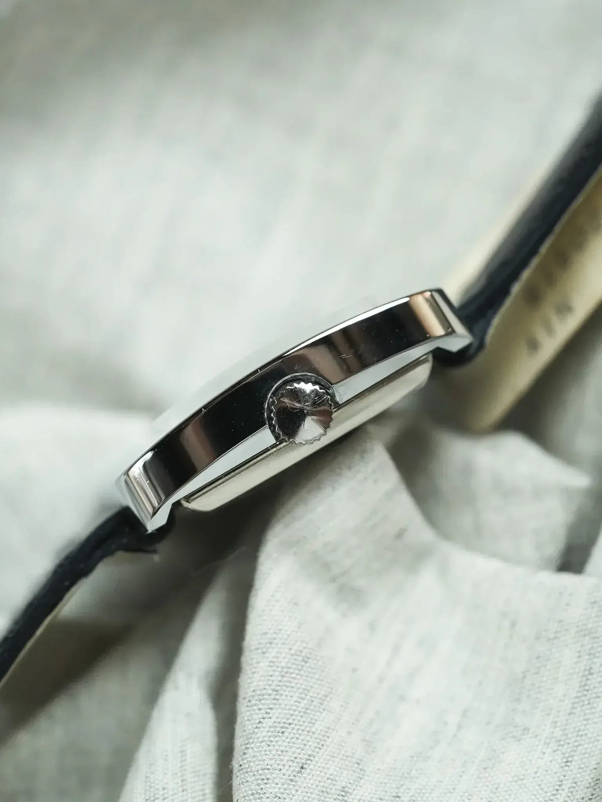 Vintage Cartier Tank watch with polished steel case and black leather strap