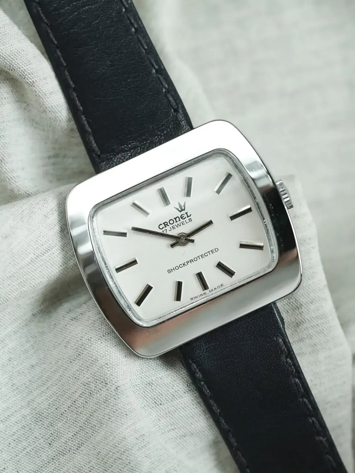 Cronel vintage watch with white dial, black leather strap, and cushion case