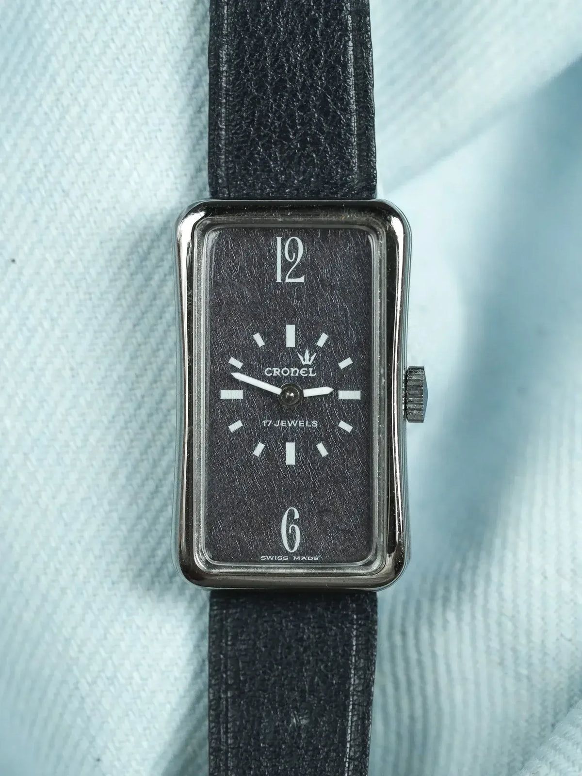 Cronel vintage watch with rectangular case, black dial, white markers, and black leather strap