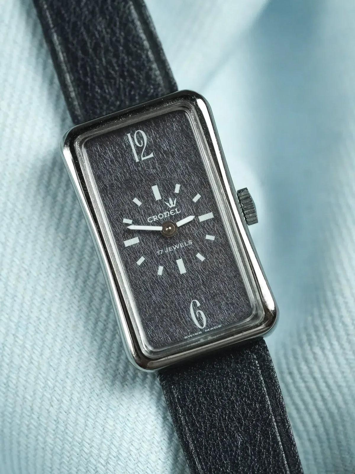 Cronel vintage watch with rectangular case, black textured dial, white markers, black leather strap