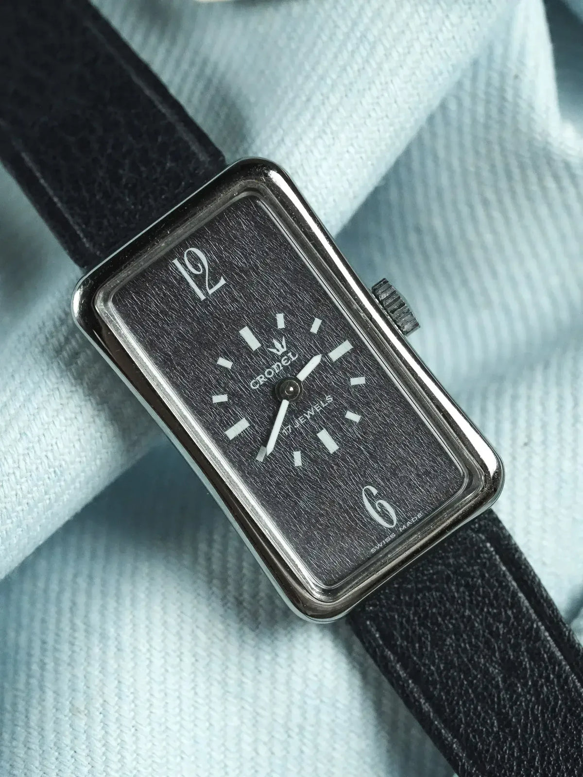 Cronel vintage watch with rectangular case, black textured dial, white markers, and black leather strap