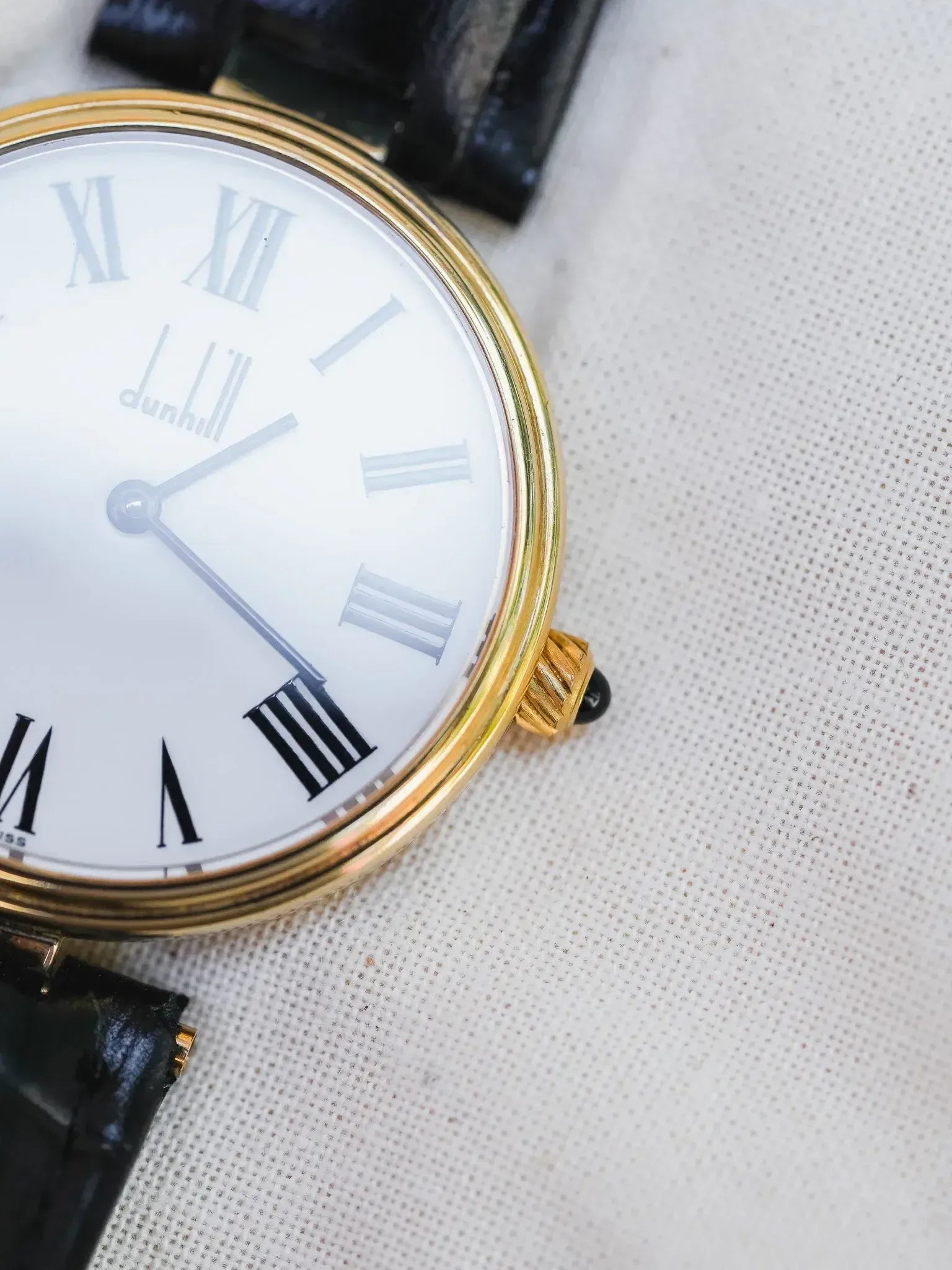 Dunhill vintage watch with gold case, white dial, Roman numerals, black leather strap