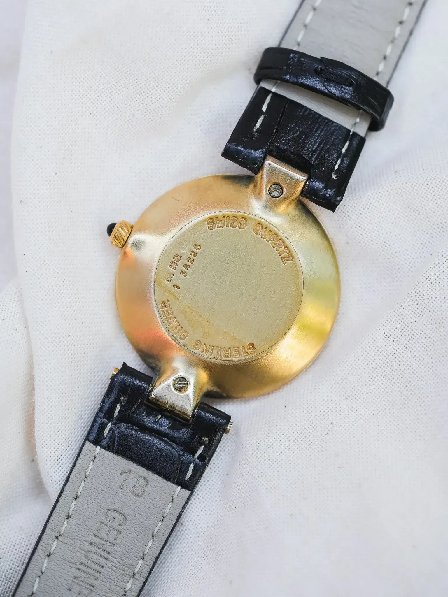 Vintage Swiss Quartz watch back, sterling silver case, black leather strap with white stitching