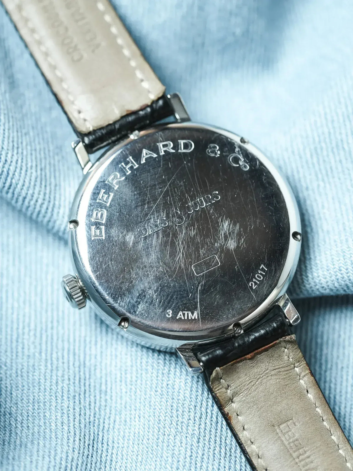Eberhard & Co vintage watch back, steel case, leather strap on denim