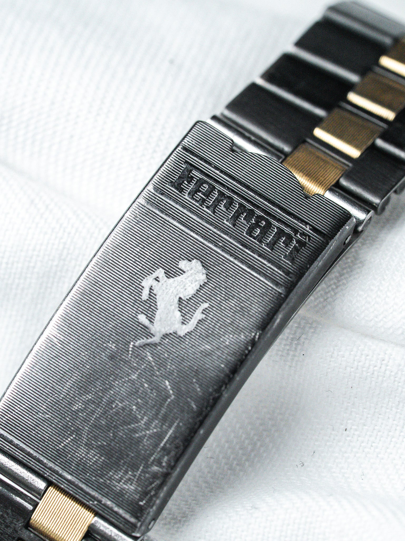 Ferrari vintage watch clasp with prancing horse logo, two-tone metal bracelet