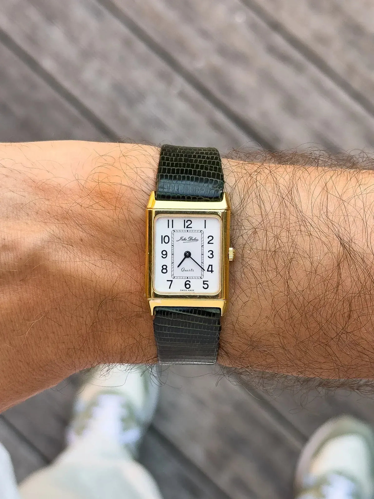 Jaeger-LeCoultre vintage watch with gold case, white dial, black lizard strap on wrist