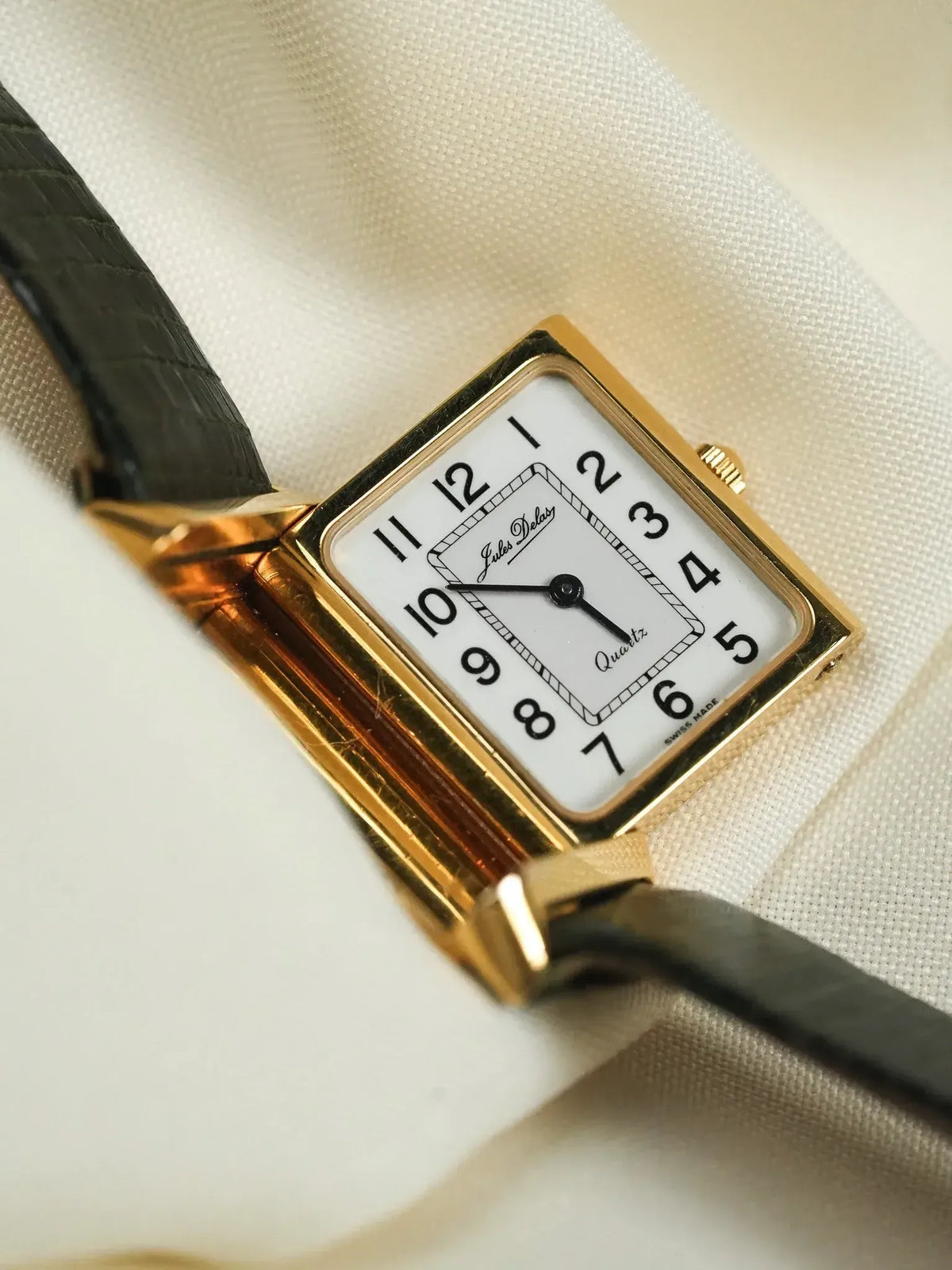 Jules Delar vintage watch with gold case, white dial, black leather strap