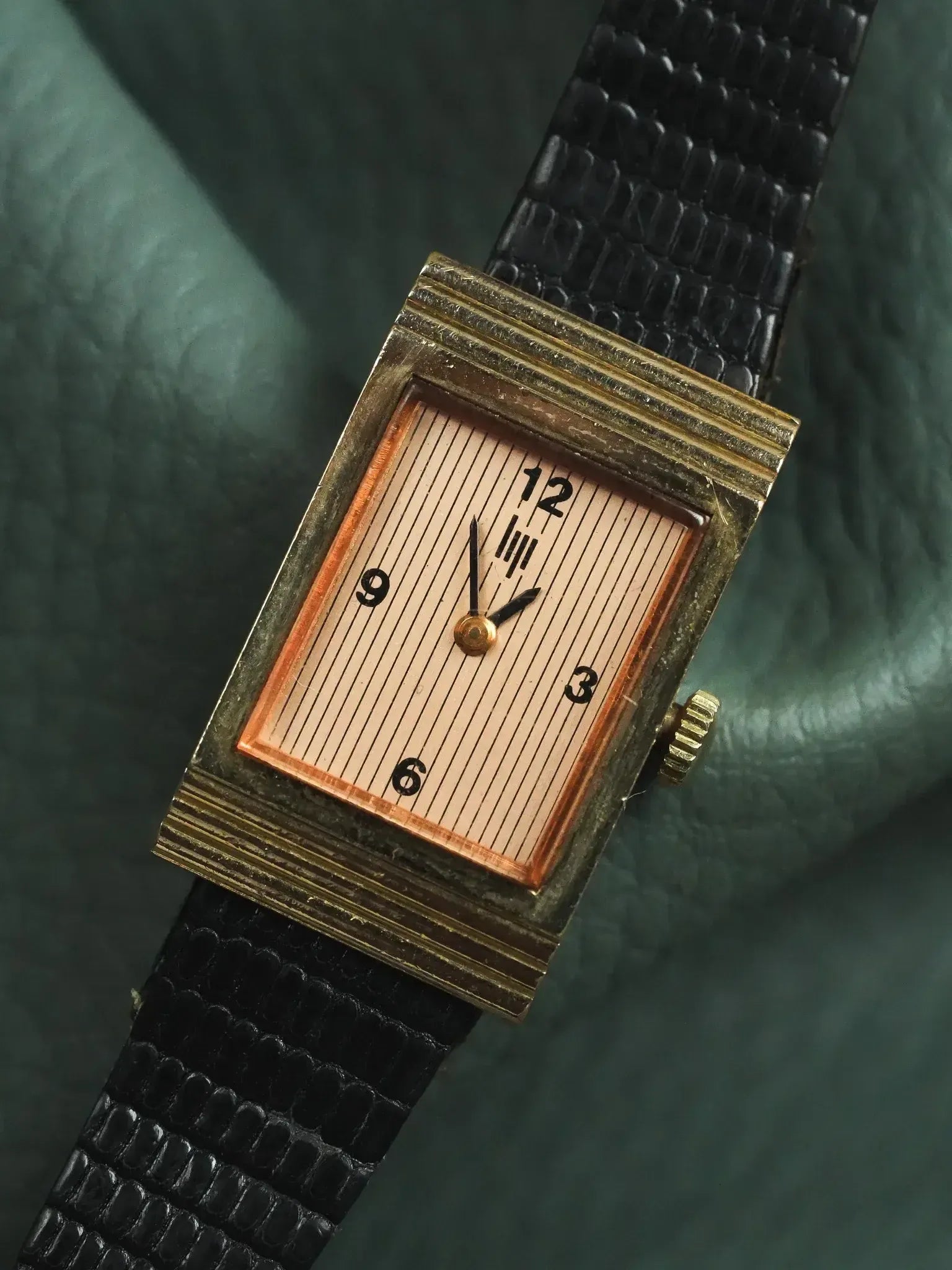 Vintage rectangular watch with gold case, striped dial, black leather strap