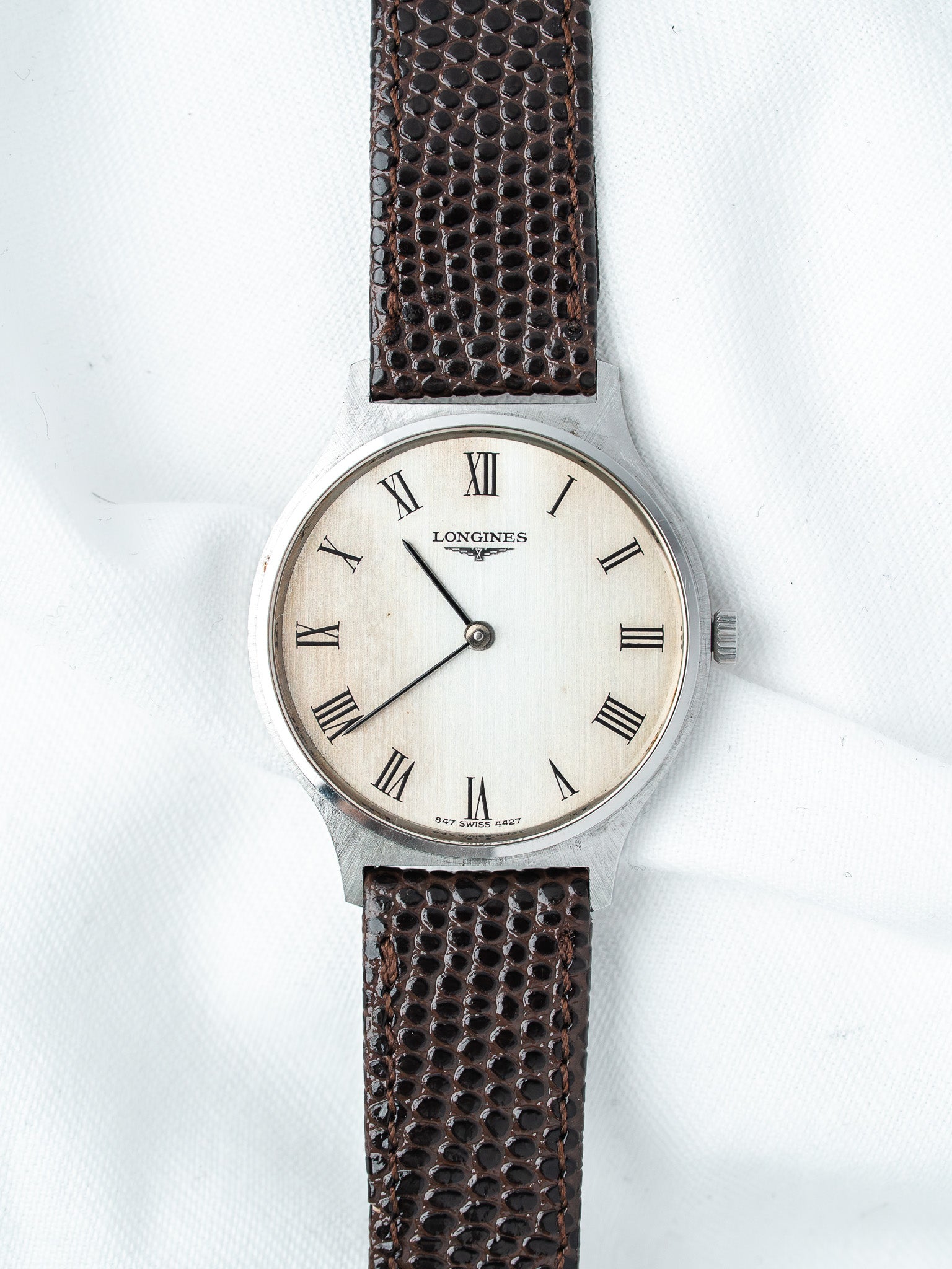 Longines vintage watch with white dial, Roman numerals, brown textured strap