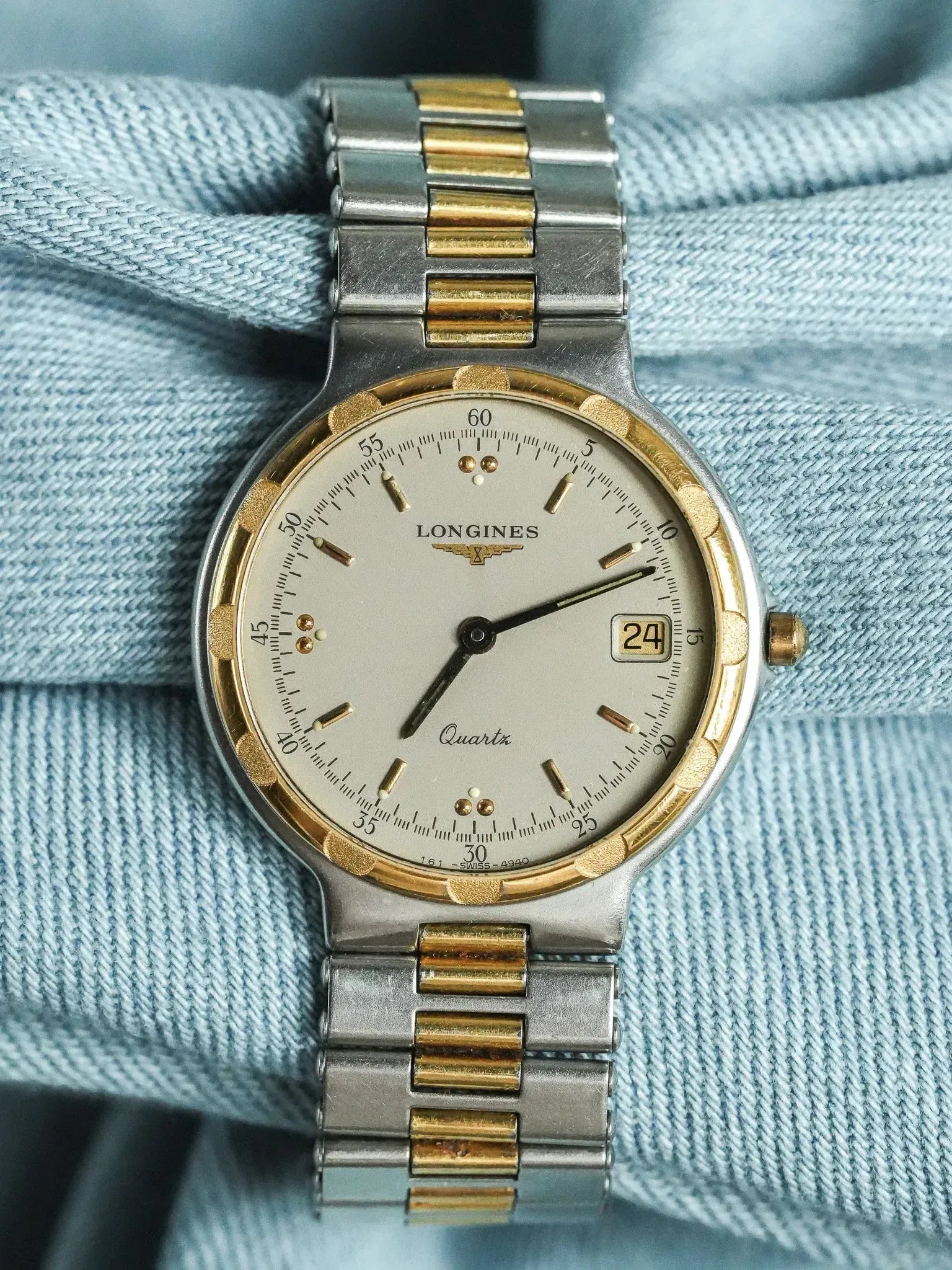 Longines vintage quartz watch with two-tone steel and gold bracelet, silver dial on denim