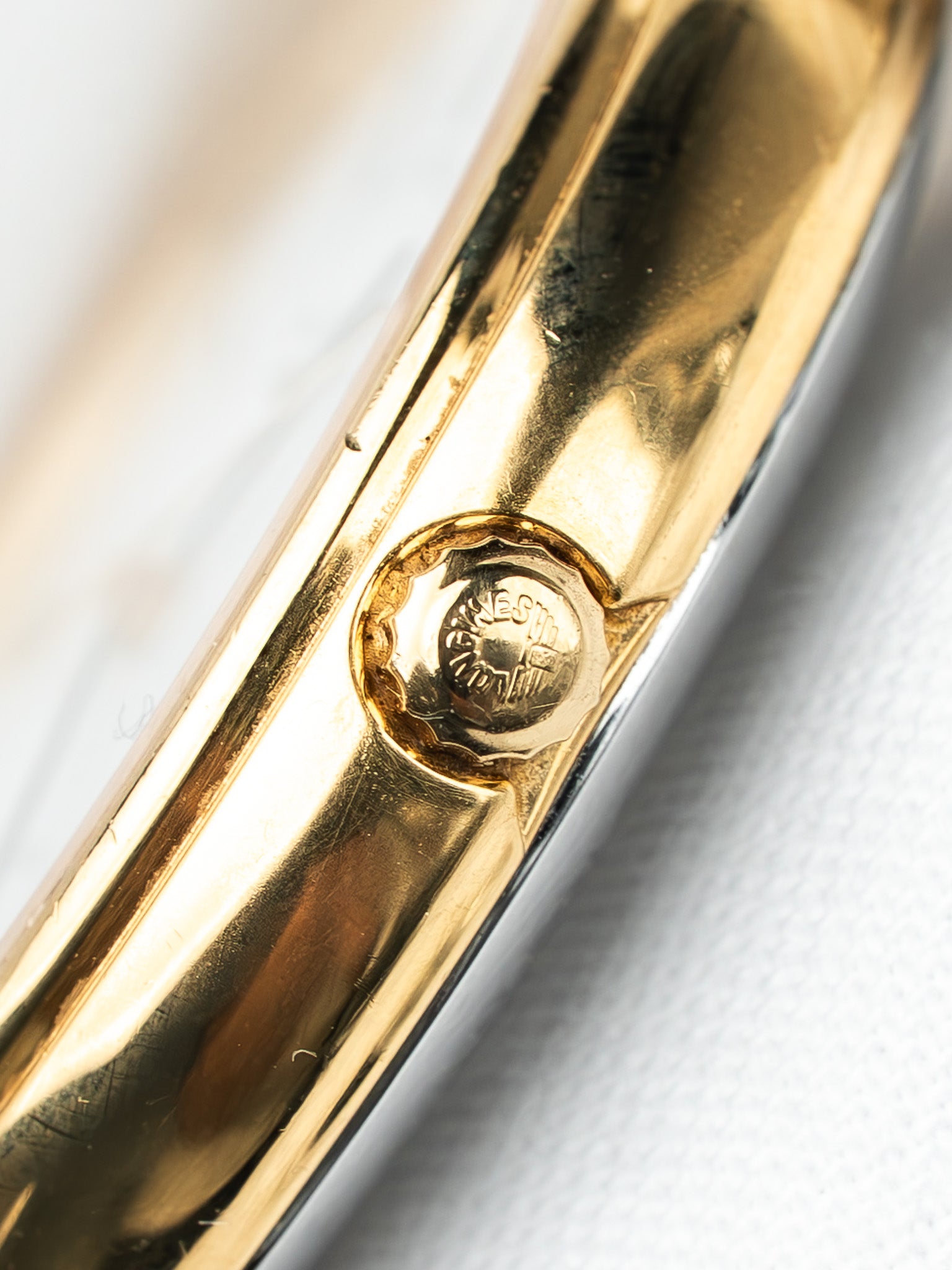 Vintage Cartier watch case back with gold finish and engraved logo detail