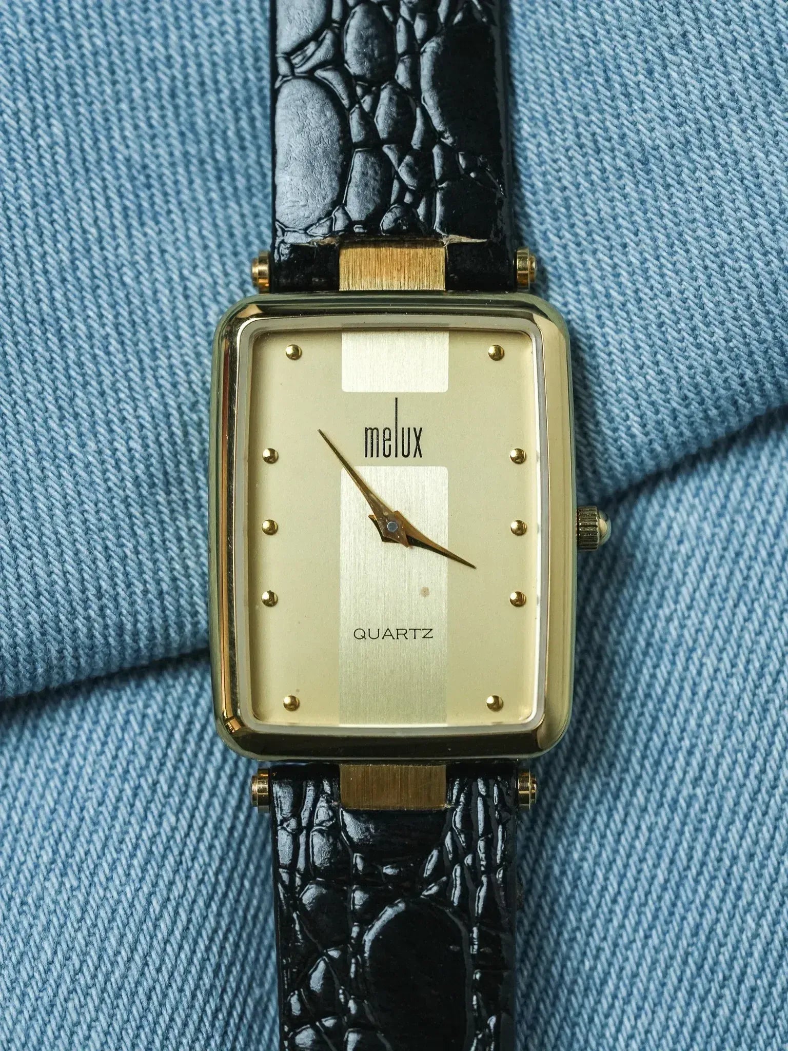 Melux vintage quartz watch, gold case, cream dial, black croco strap on denim