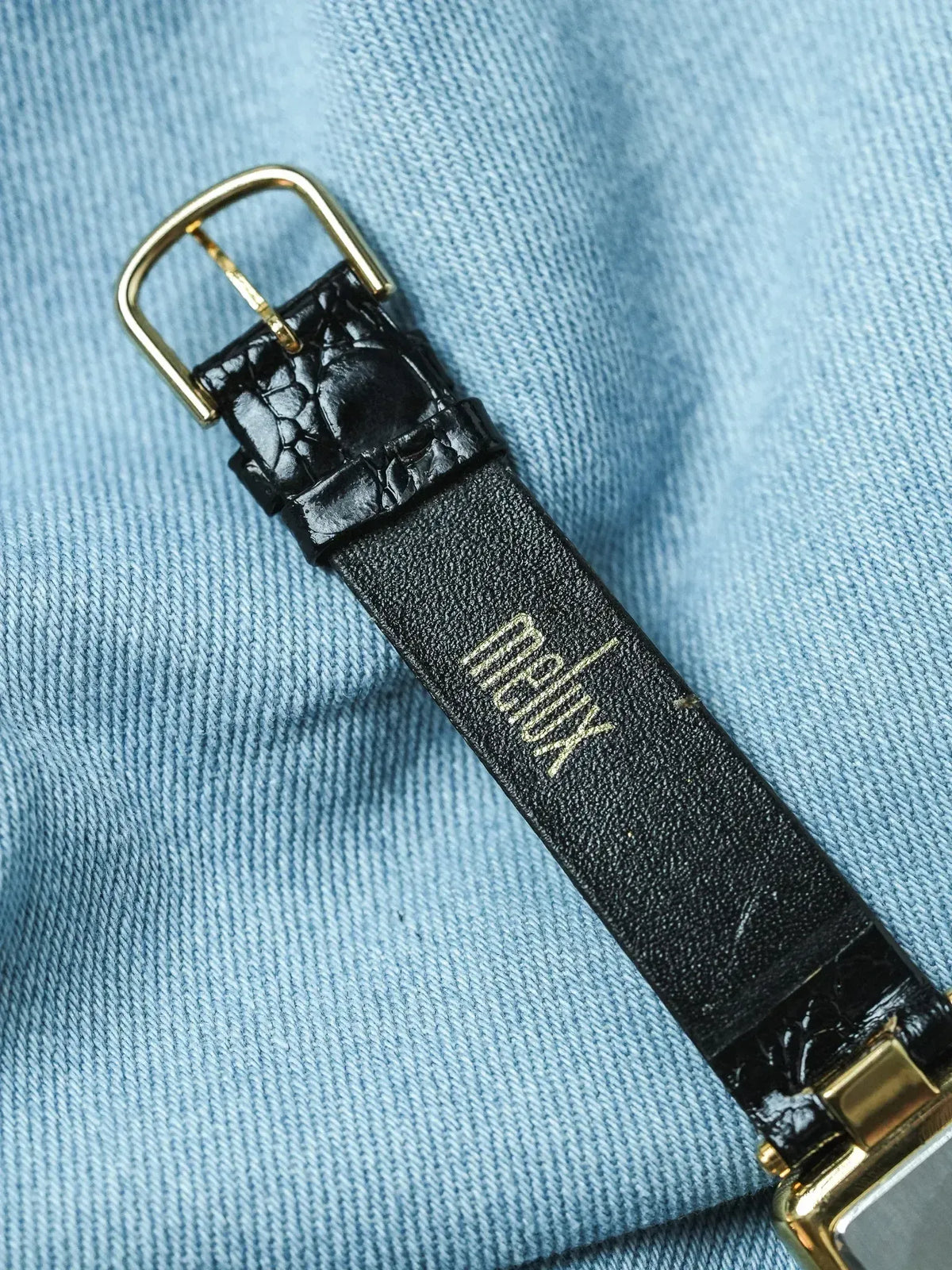 Black crocodile leather watch strap with gold buckle, Xerjoff branding visible
