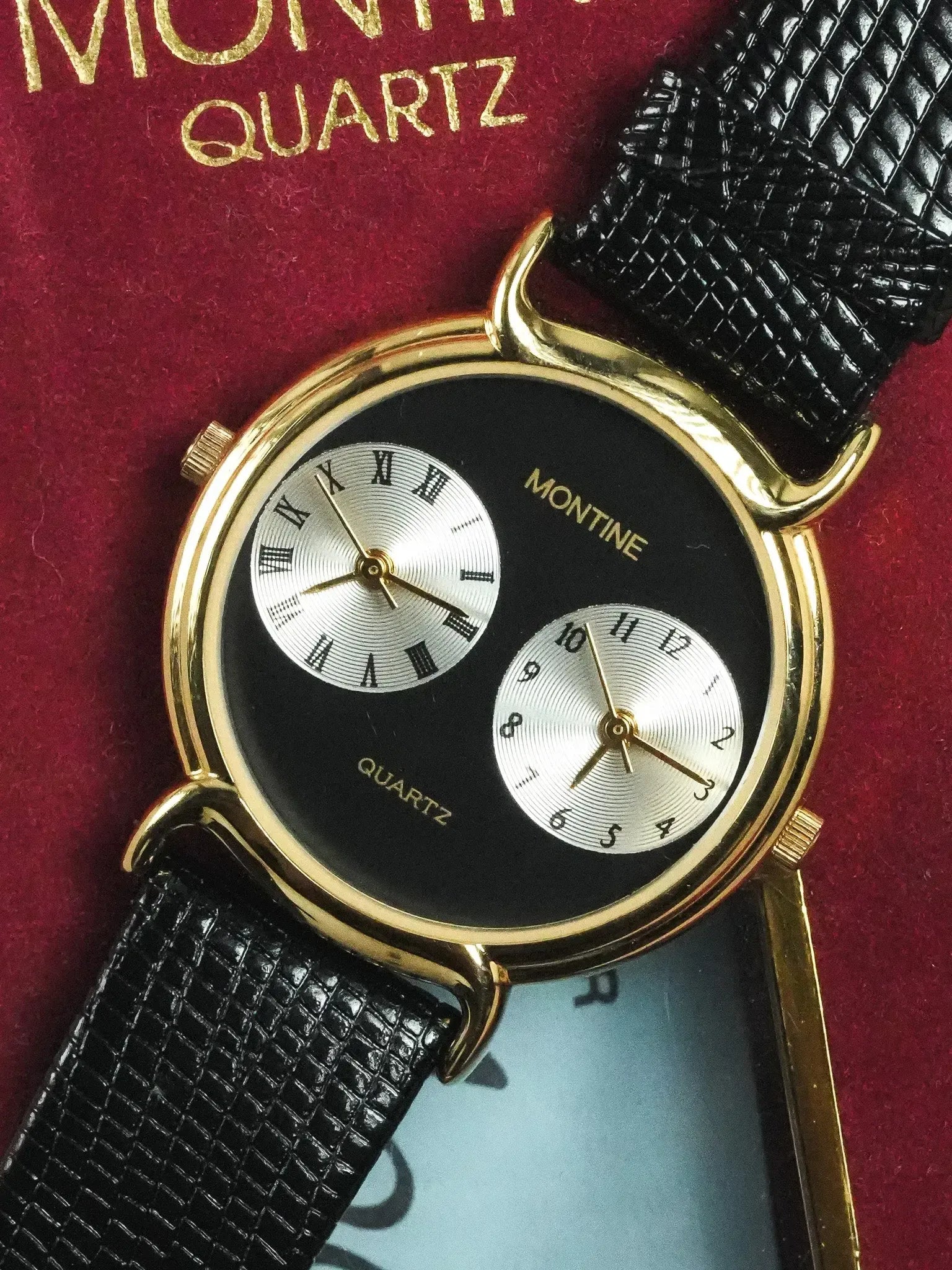 Montine vintage quartz watch with gold case, black dial, and black textured strap