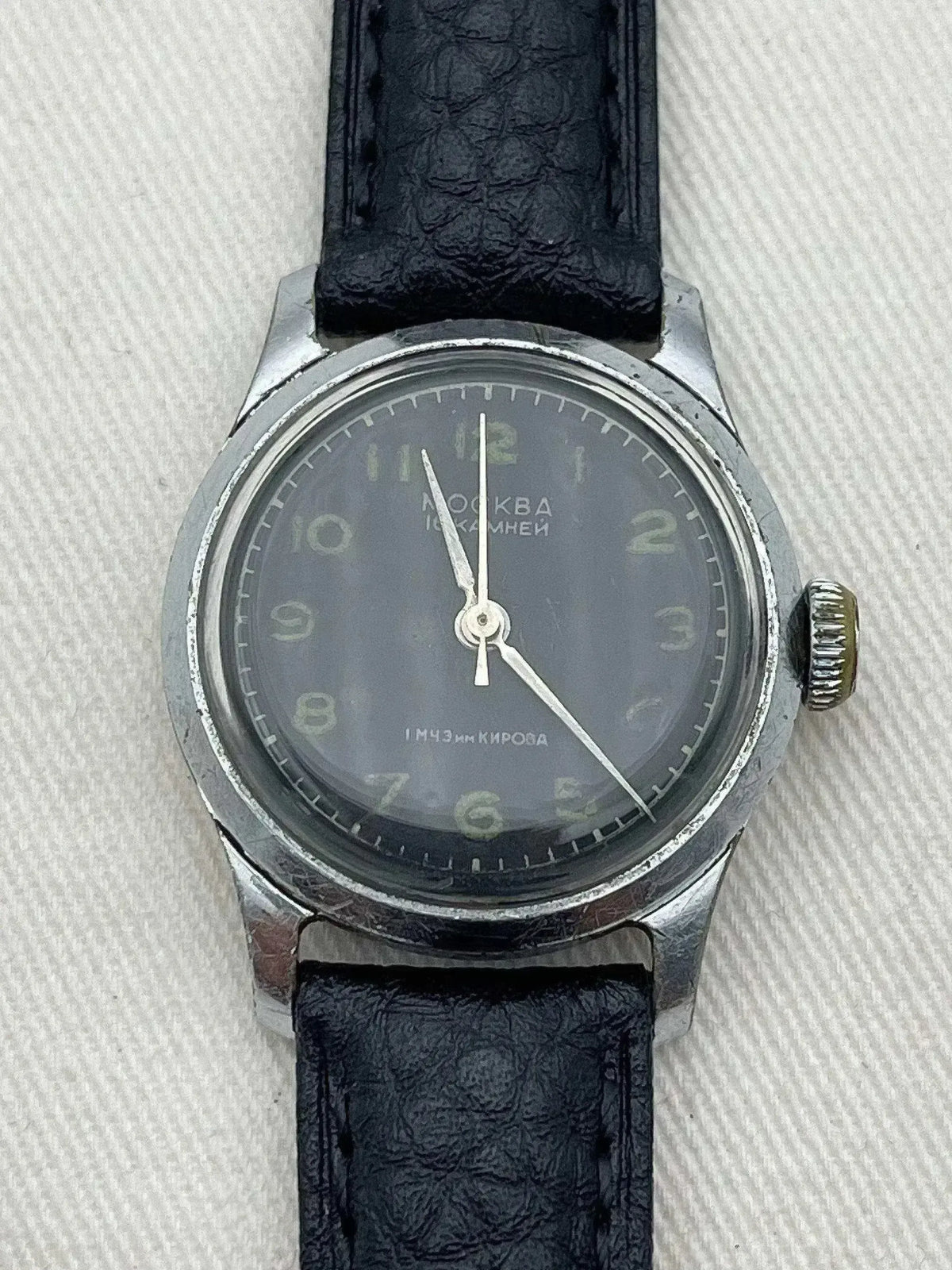 Vintage Moscow watch with gray dial, black leather strap, and Cyrillic text on face