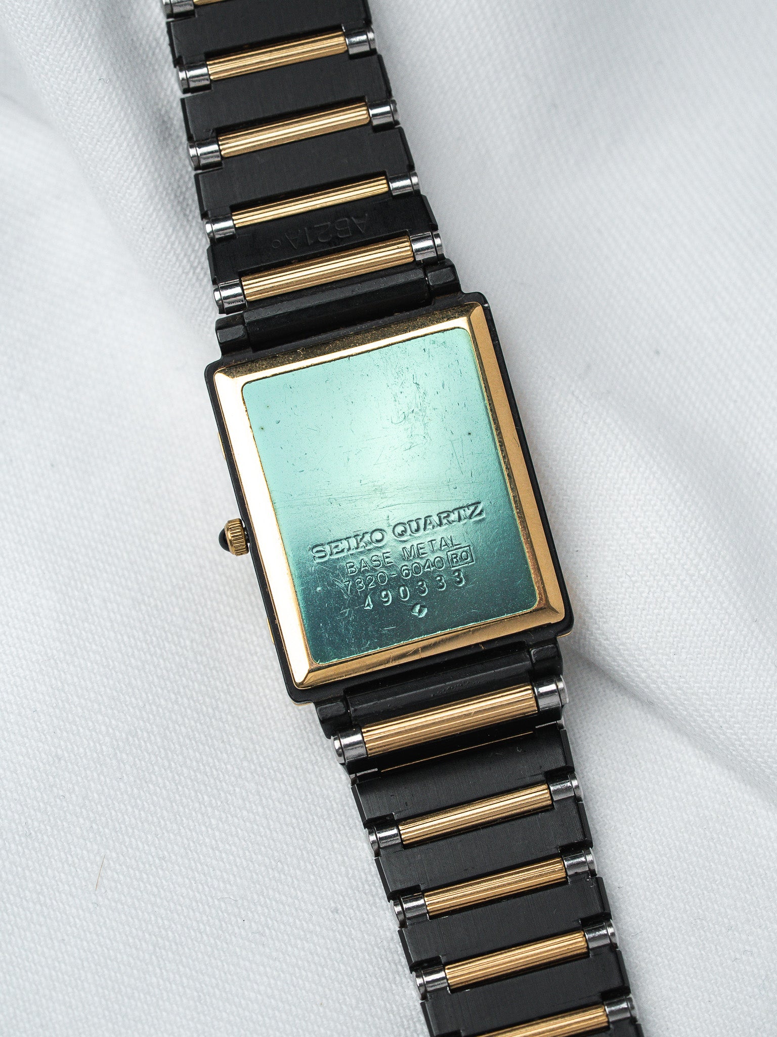 Seiko Quartz vintage watch with black and gold bracelet, green case back