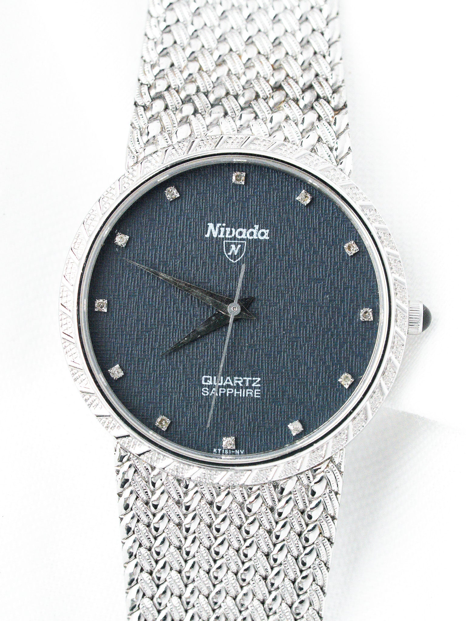 Nivada vintage watch with blue dial, diamond markers, and textured metal bracelet
