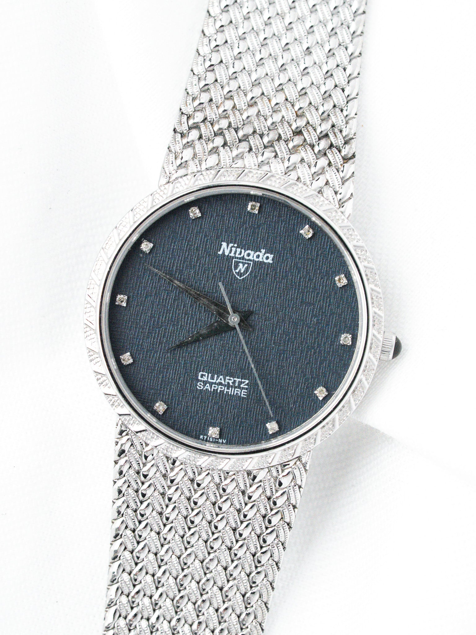 Nivada vintage watch with blue dial, diamond markers, and mesh bracelet