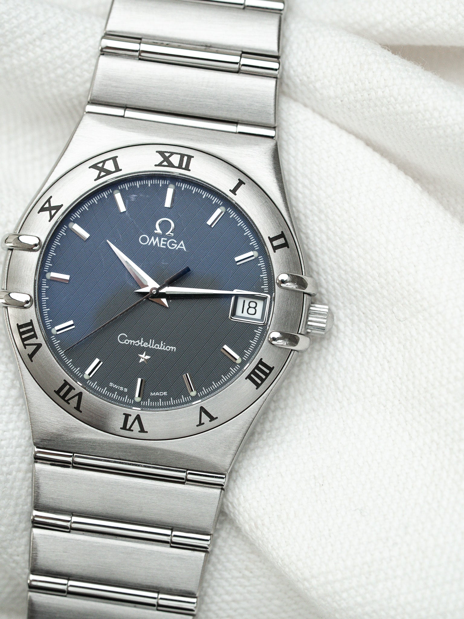 Omega Constellation watch with blue dial, stainless steel bracelet, Roman numerals, date window