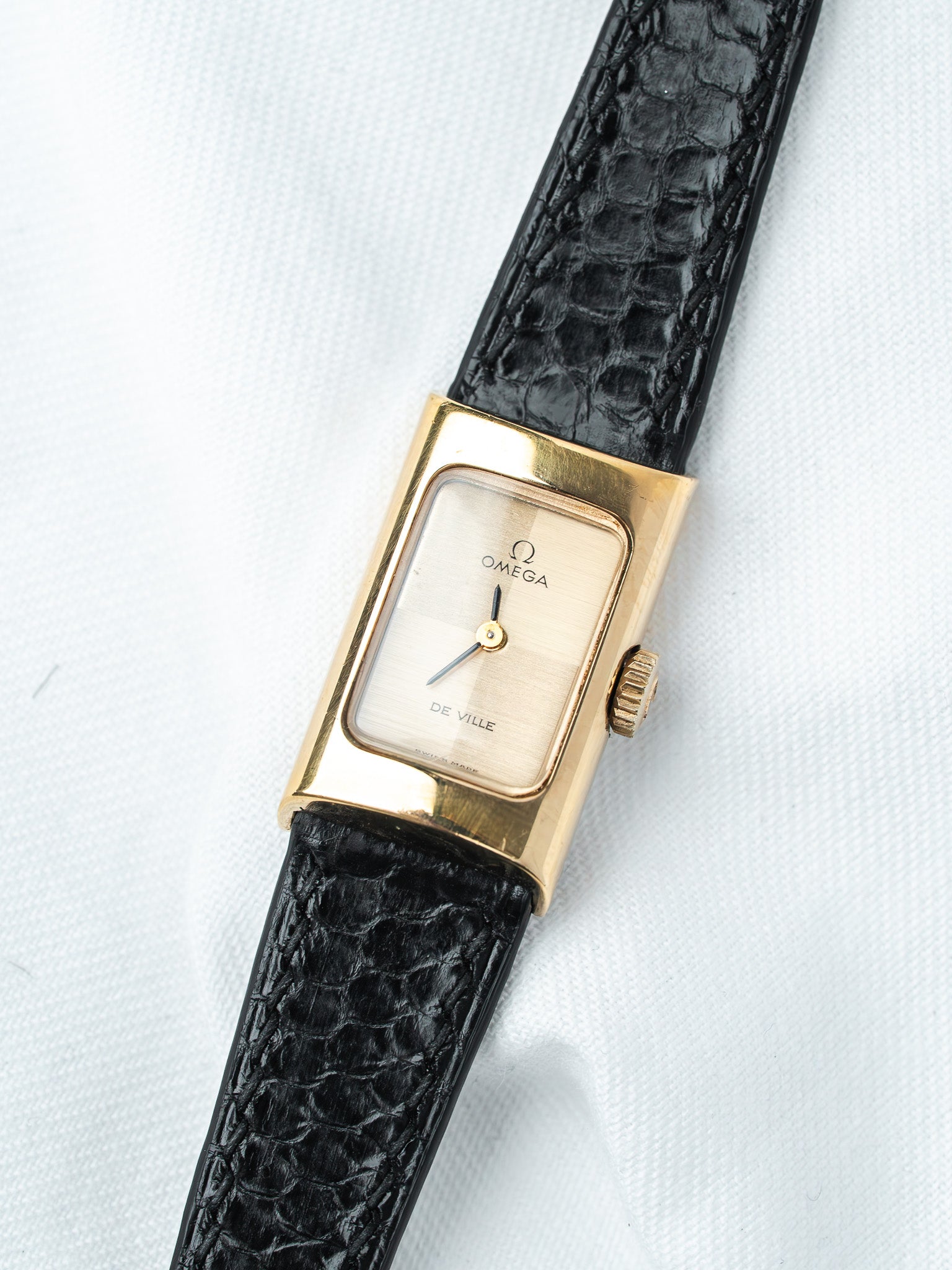Omega De Ville vintage watch with gold case, cream dial, black alligator strap