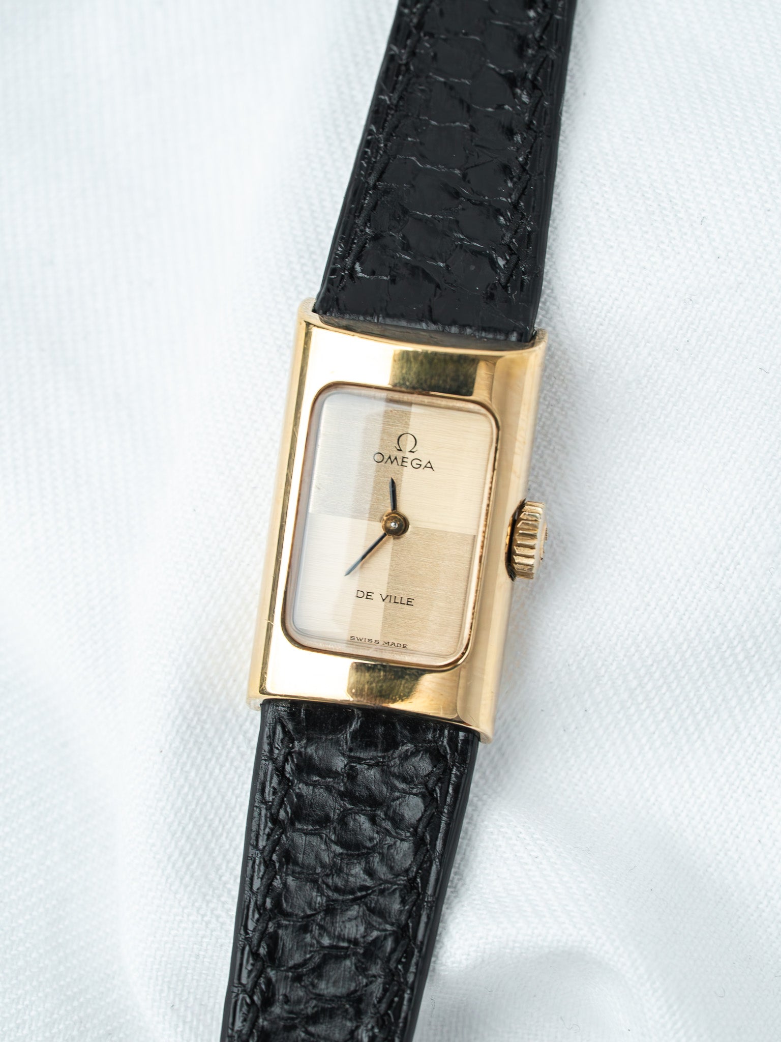Omega De Ville vintage watch with gold case, white dial, black leather strap