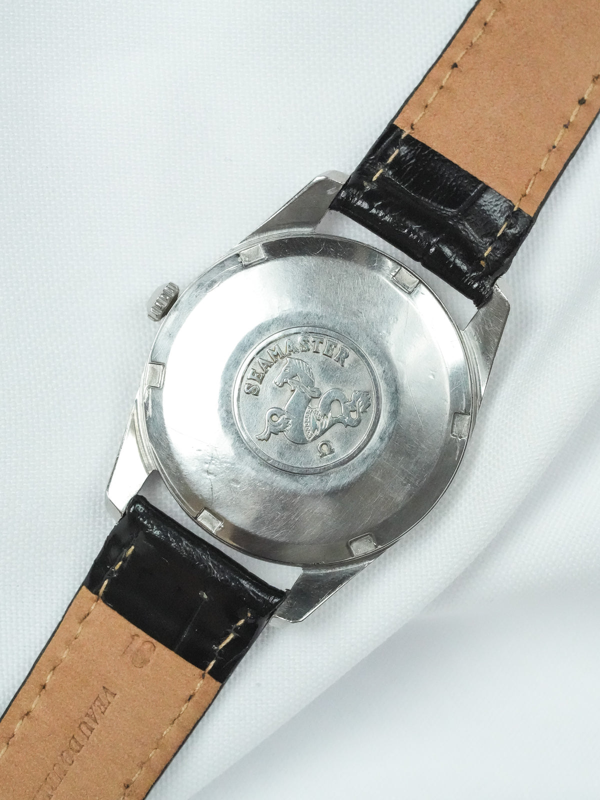 Omega Seamaster vintage watch back with engraved logo, steel case, black leather strap