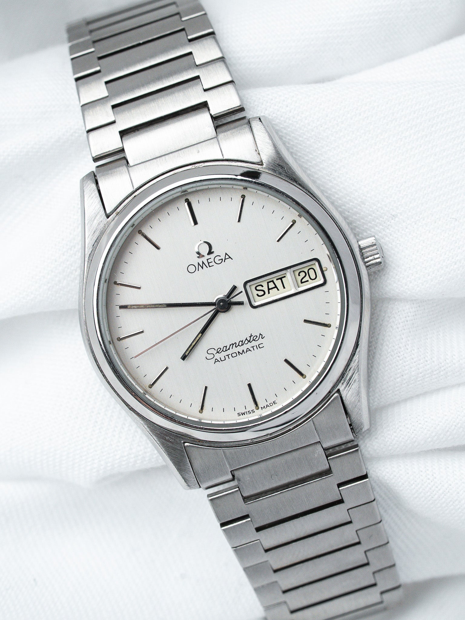 Omega Seamaster vintage automatic watch with silver dial, day-date window, and steel bracelet