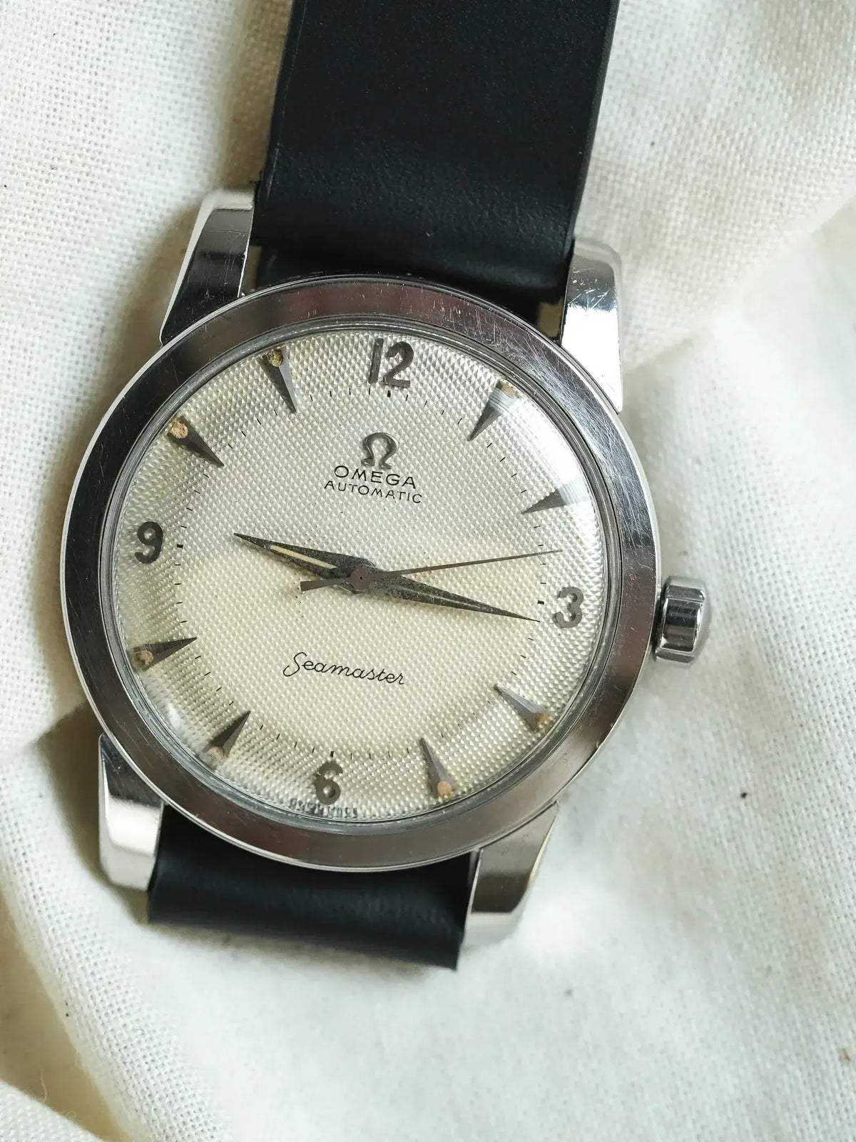 Vintage Omega Seamaster automatic watch with silver textured dial and black leather strap