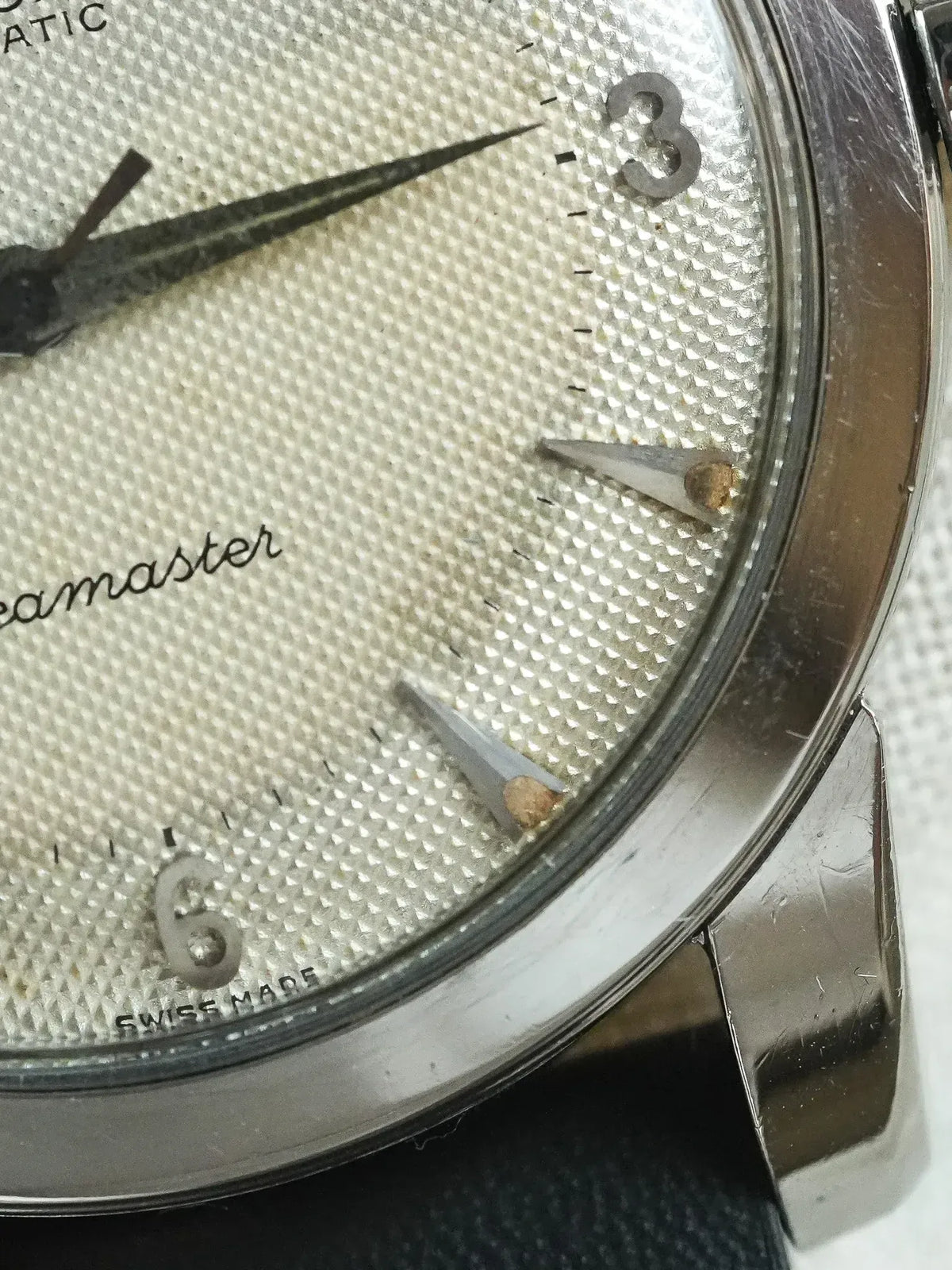 Omega Seamaster vintage watch with textured silver dial and applied hour markers