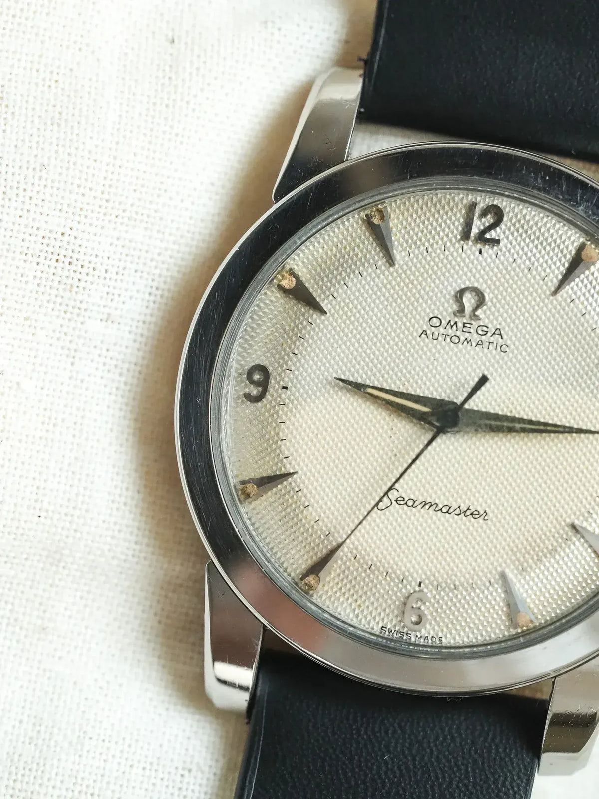 Vintage Omega Seamaster automatic watch with silver textured dial and black leather strap