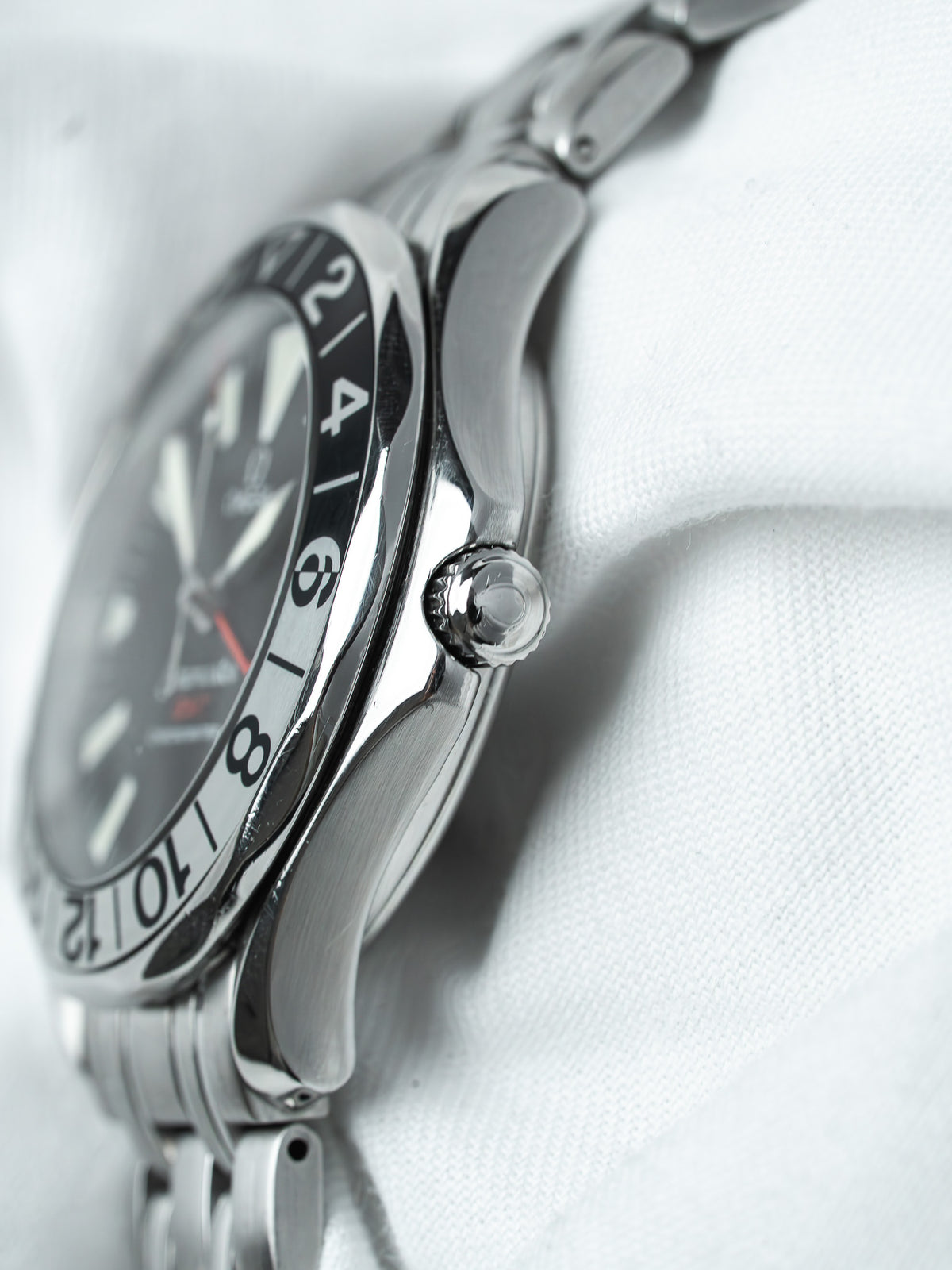 Omega Seamaster vintage watch with black dial, steel case, and bracelet on white background