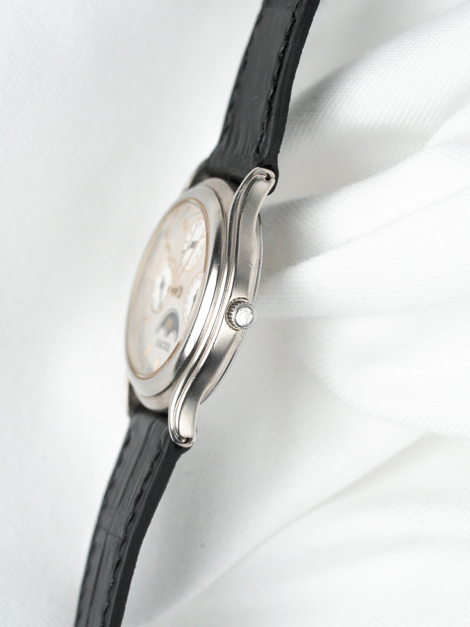 Vintage Universal Genève chronograph watch with silver case, black leather strap, white dial