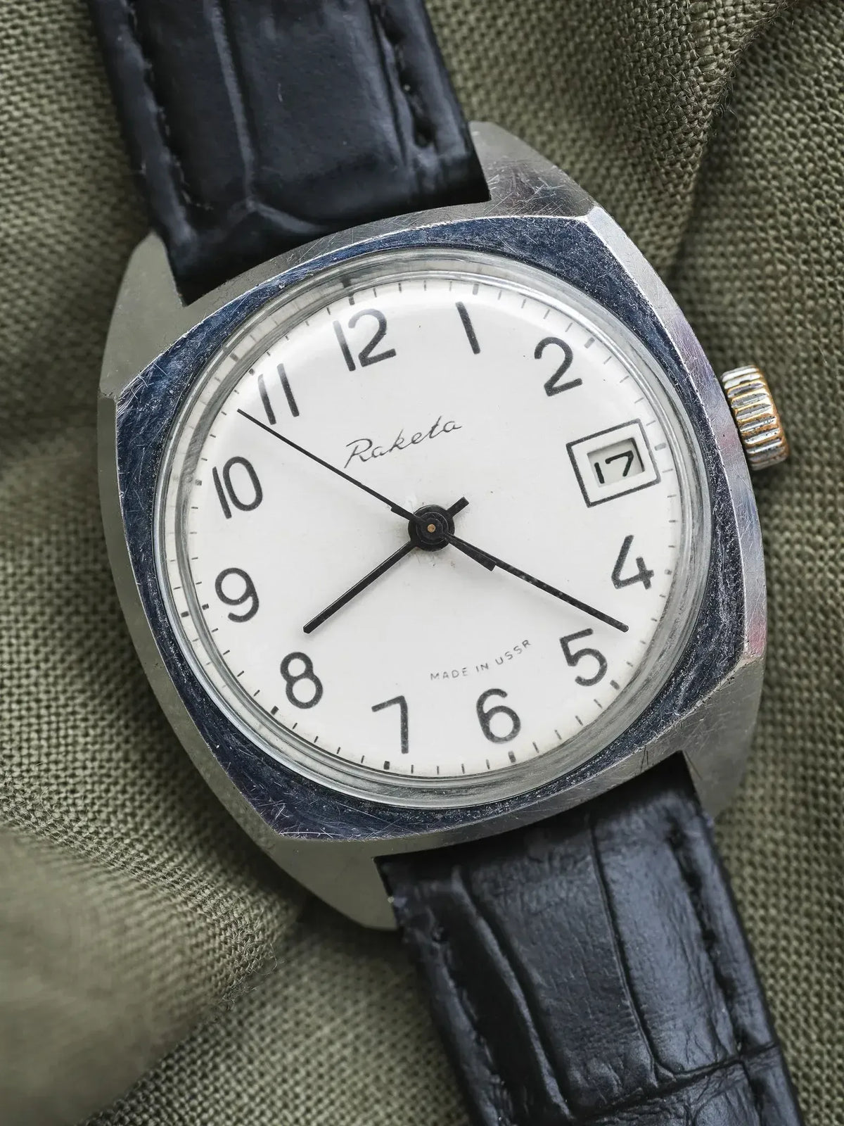 Raketa vintage watch with white dial, black leather strap, and USSR marking