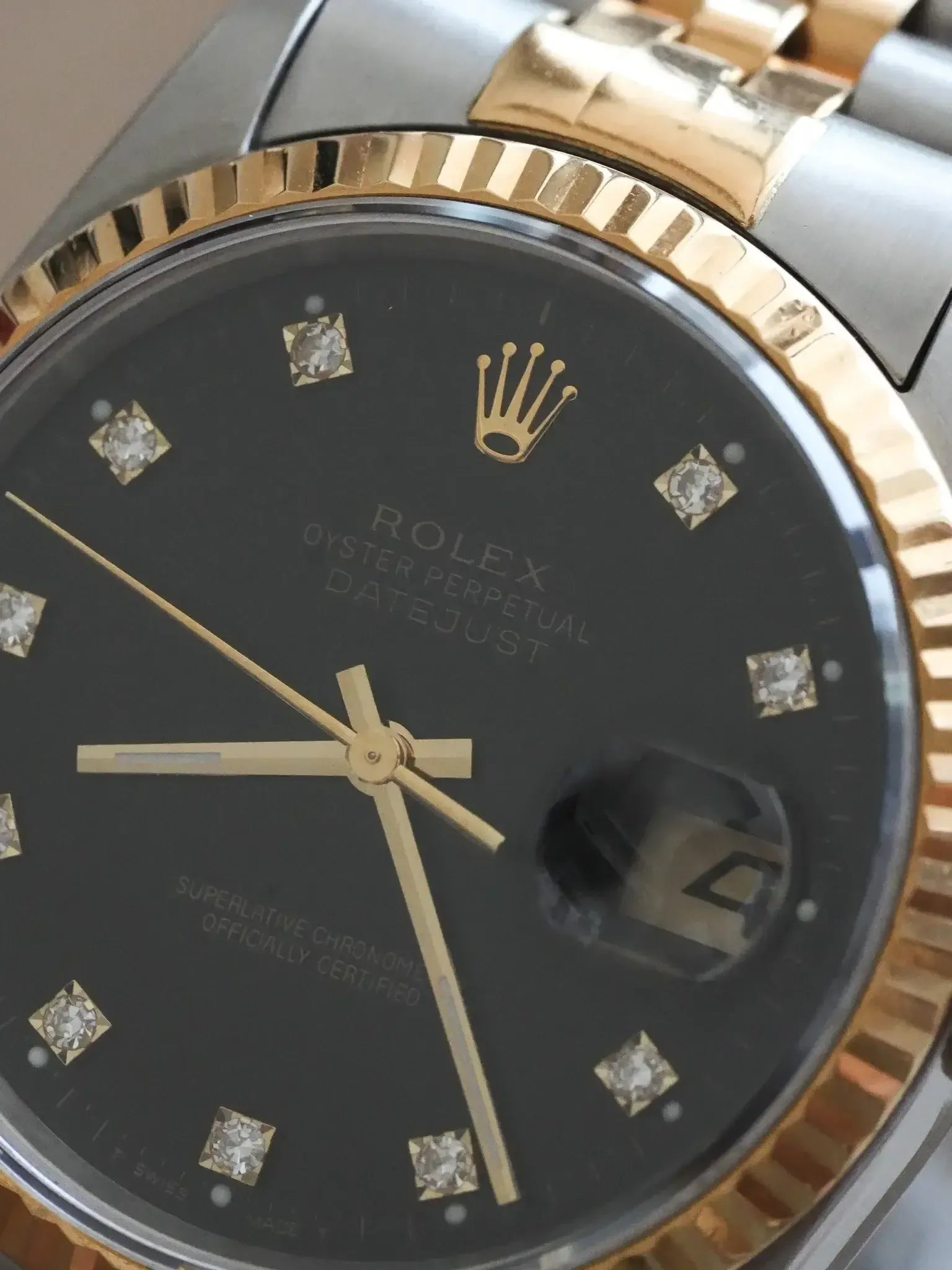 Rolex Datejust vintage with black dial, diamond hour markers, gold bezel and hands
