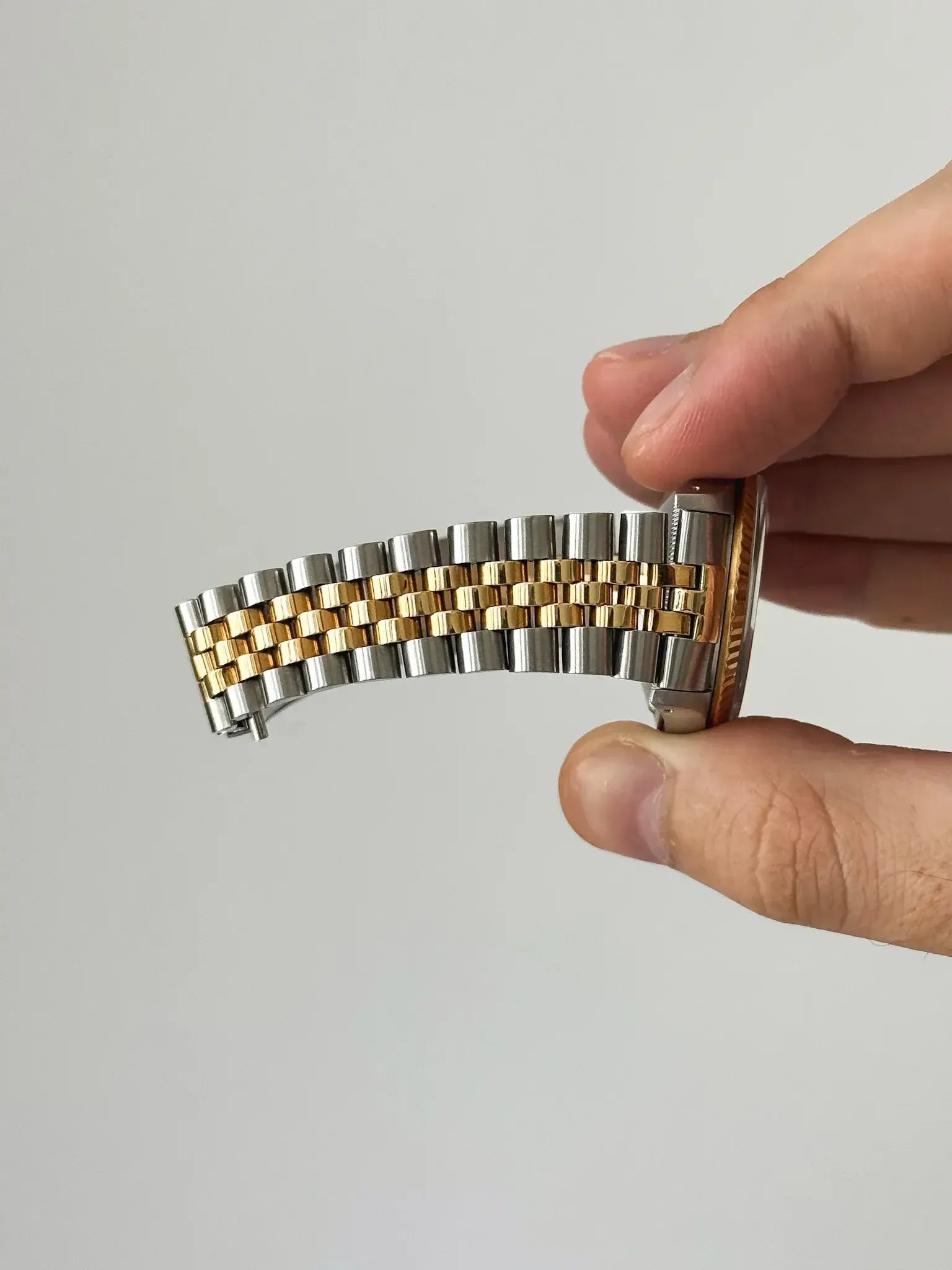 Rolex vintage two-tone bracelet with stainless steel and gold links held in hand