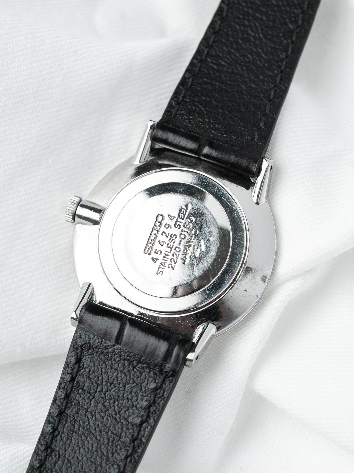 Seiko vintage watch with stainless steel case and black leather strap