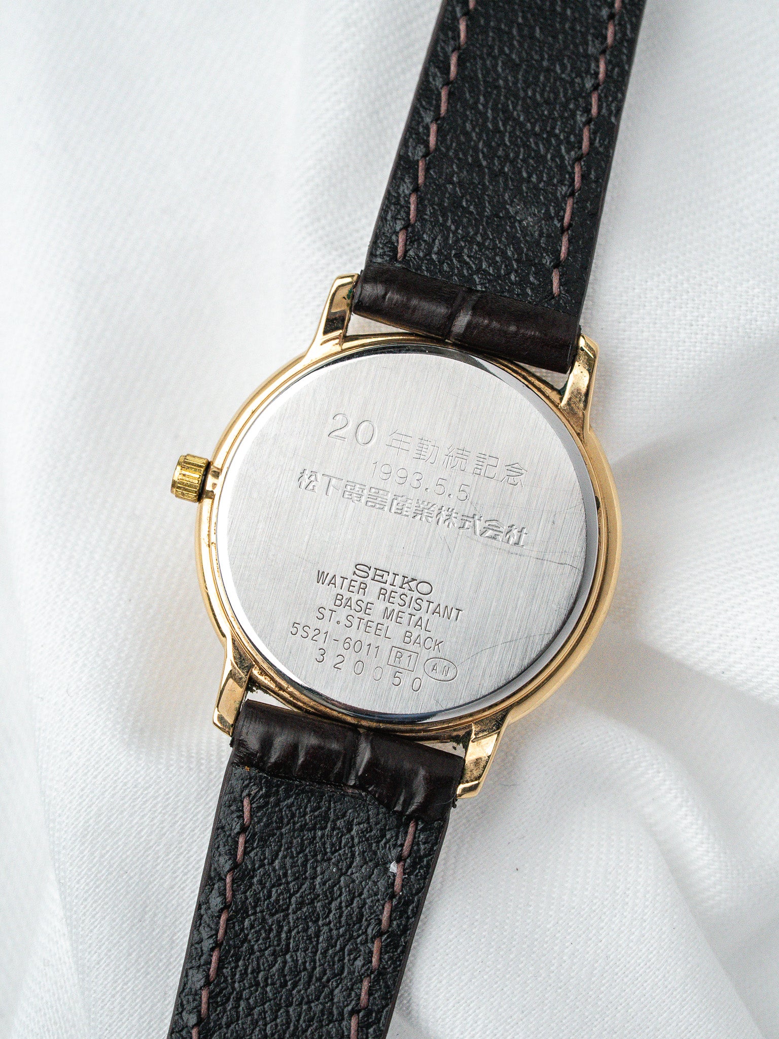 Seiko vintage watch back with 20th anniversary engraving, gold case, black leather strap