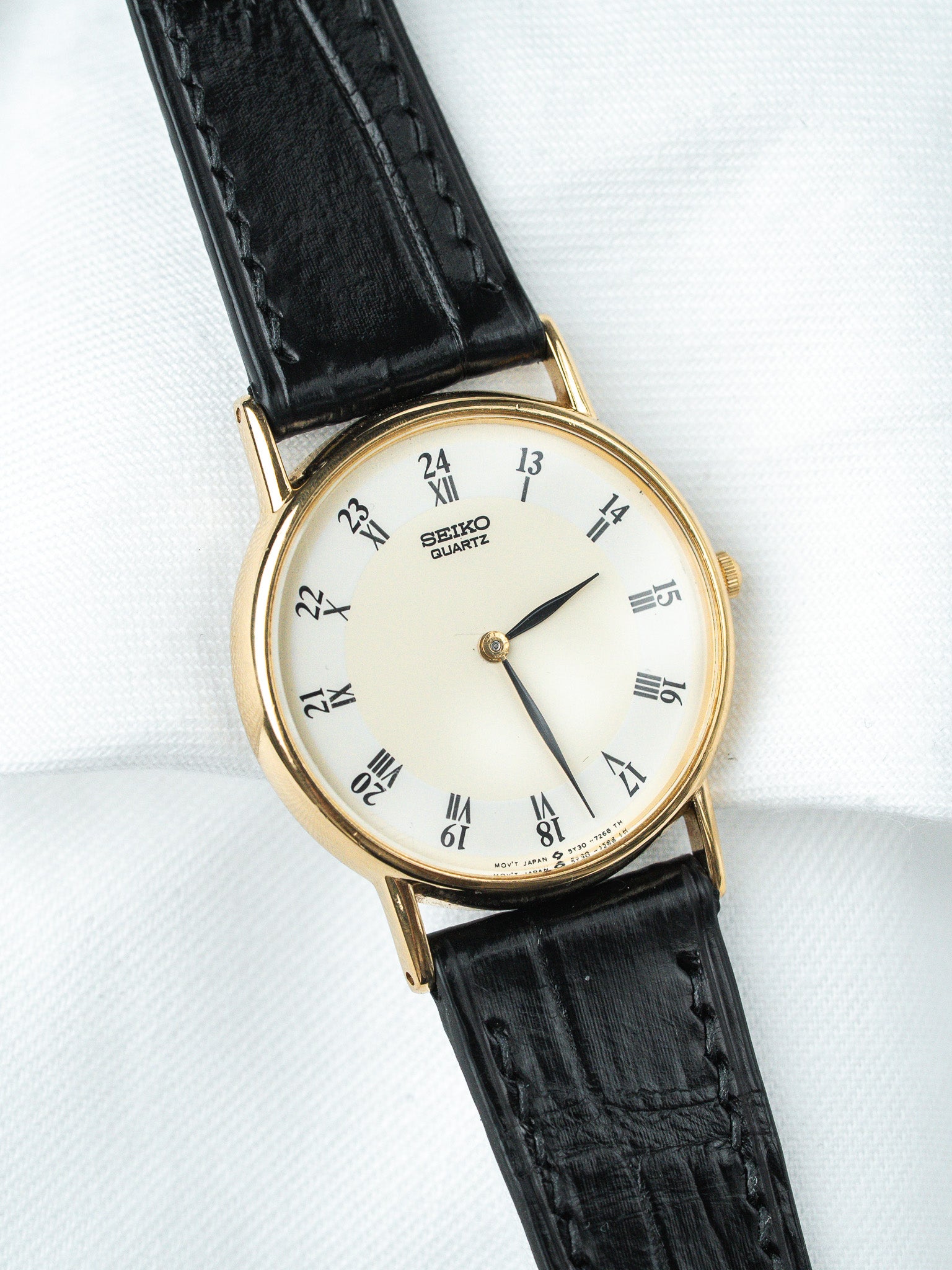 Seiko Quartz vintage watch with gold case, white dial, black leather strap