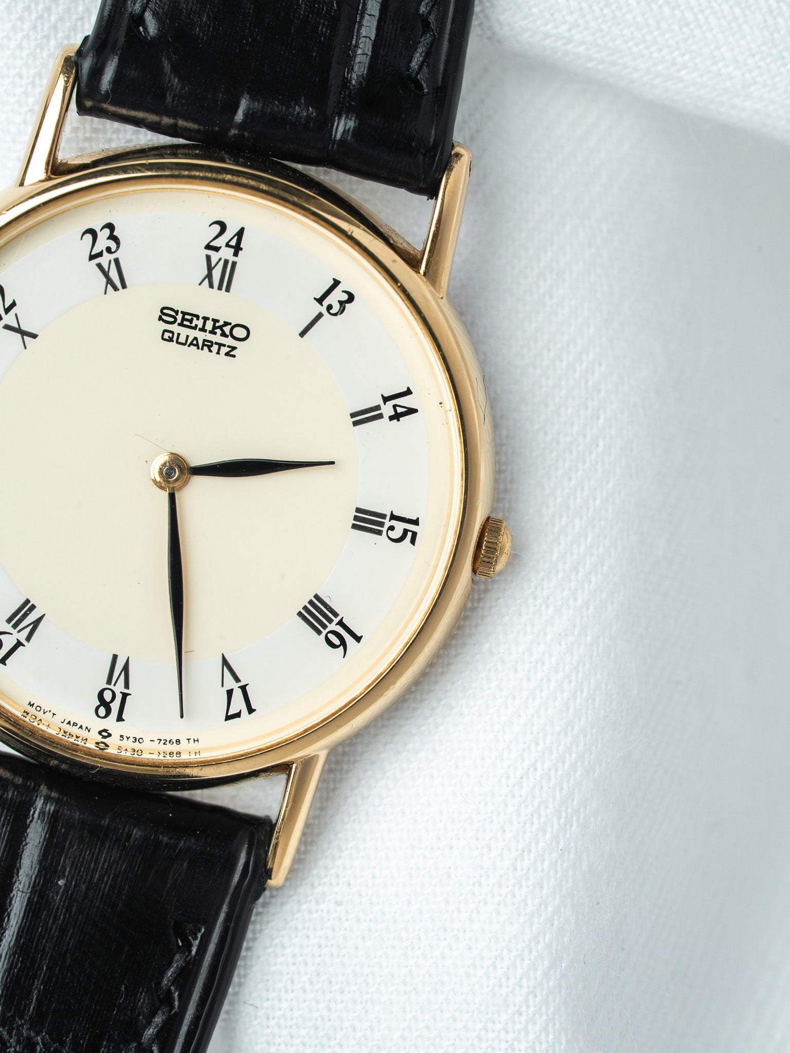 Seiko Quartz vintage watch with gold case, white dial, black leather strap