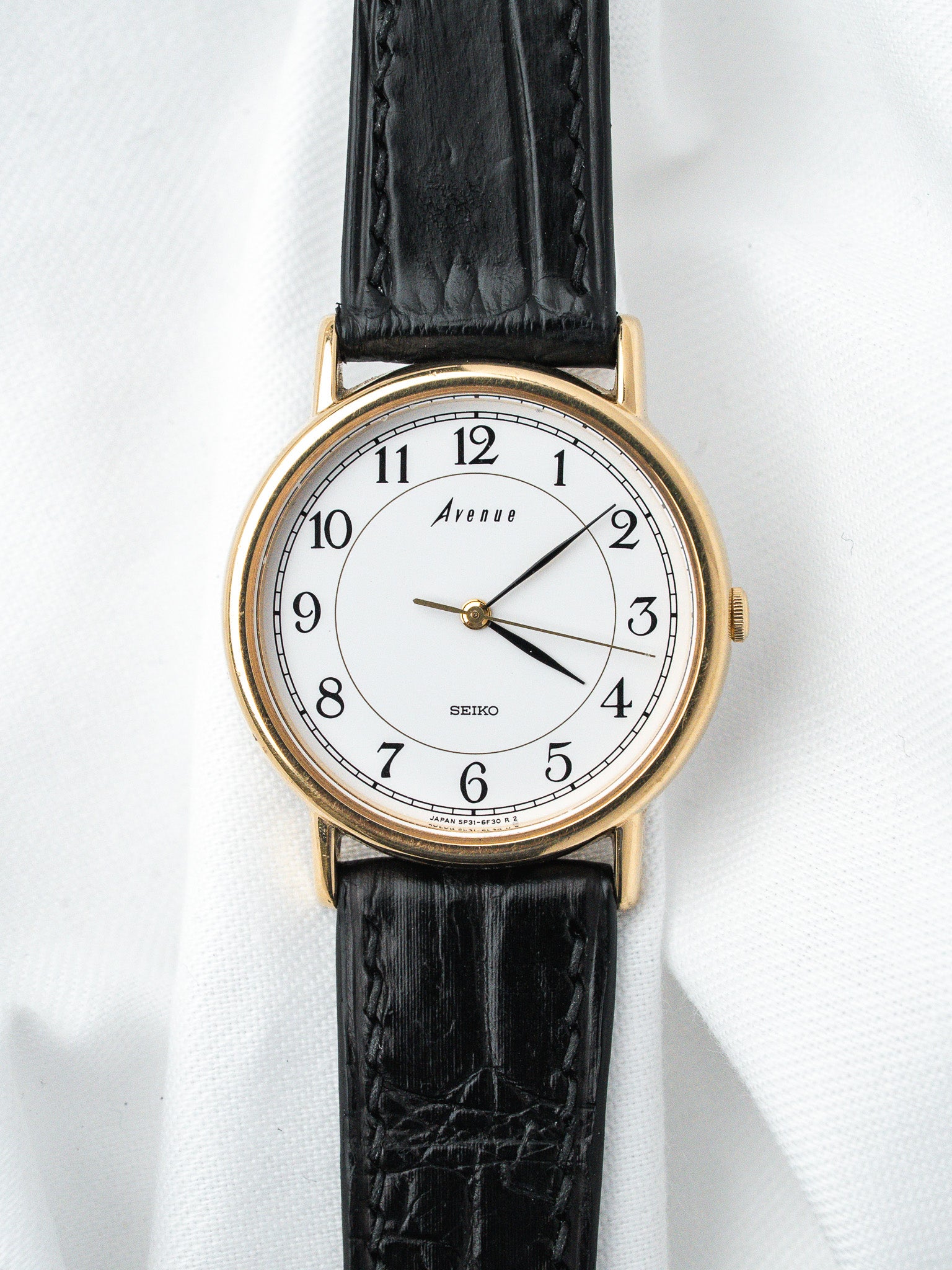 Seiko Avenue vintage watch with gold case, white dial, black leather strap