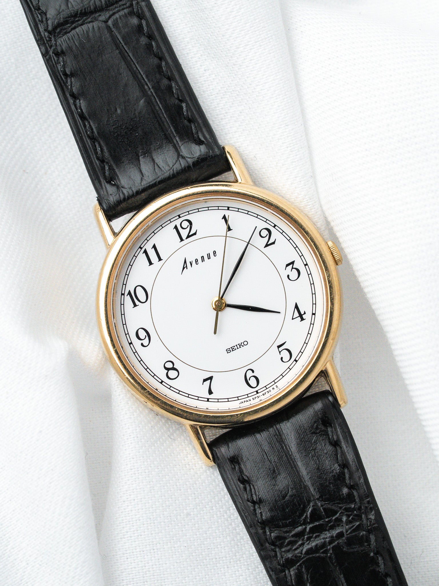 Seiko Avenue vintage watch with gold case, white dial, black leather strap