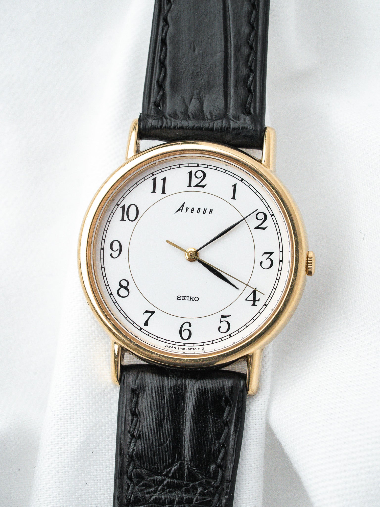 Seiko Avenue vintage watch with gold case, white dial, black leather strap