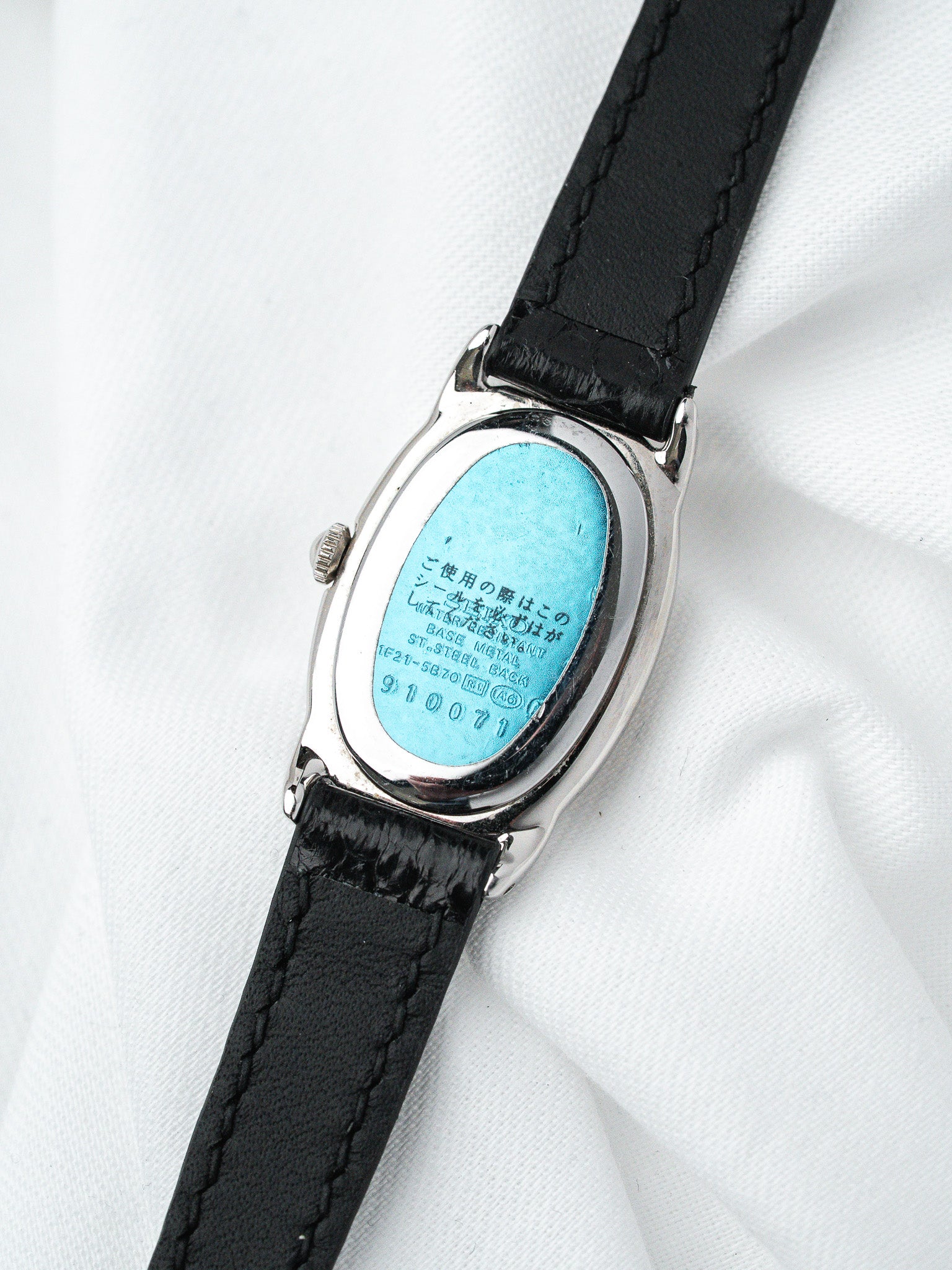 Seiko vintage watch with oval stainless steel case and black leather strap