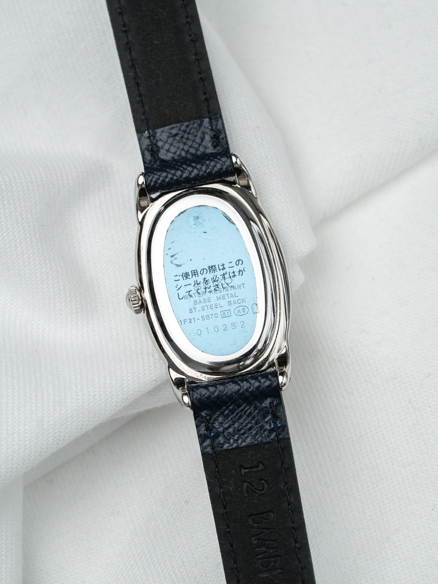 Seiko vintage watch with oval stainless steel case, blue seal, black leather strap