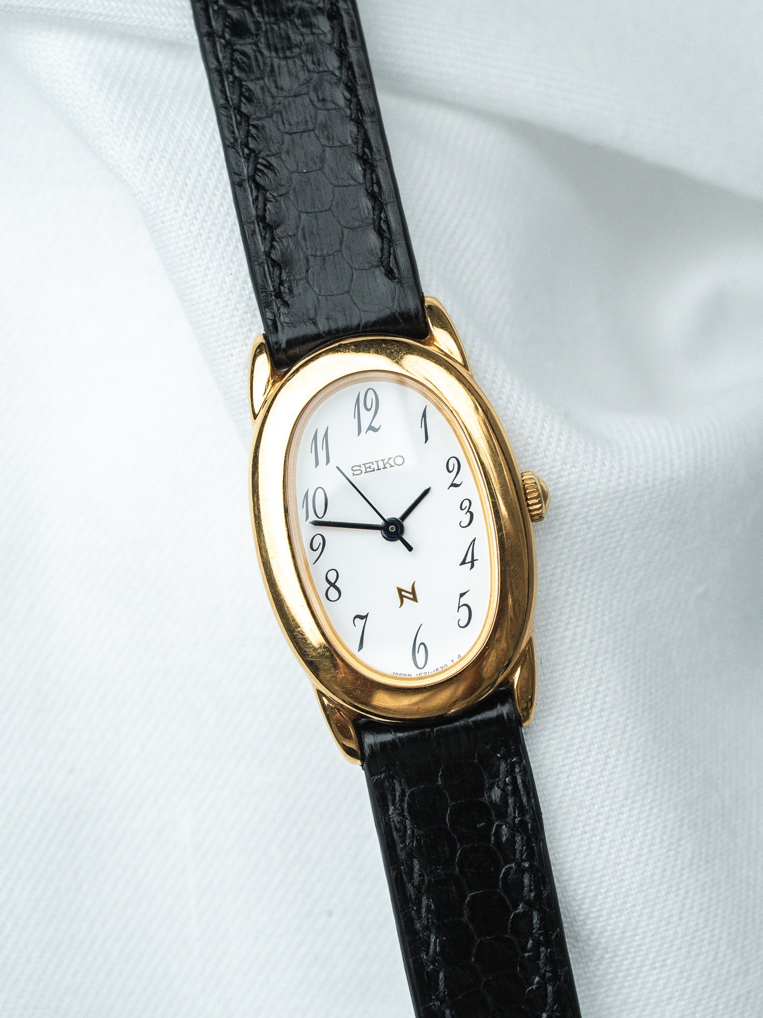 Seiko vintage watch with gold case, white dial, black alligator strap