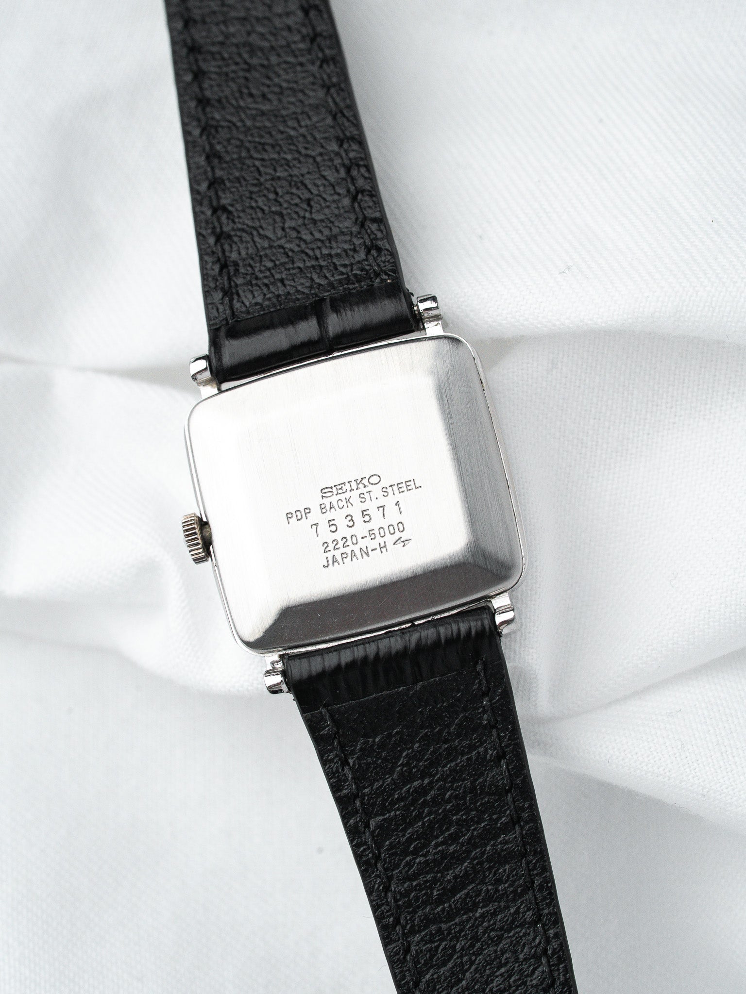 Seiko vintage watch with square stainless steel case and black leather strap