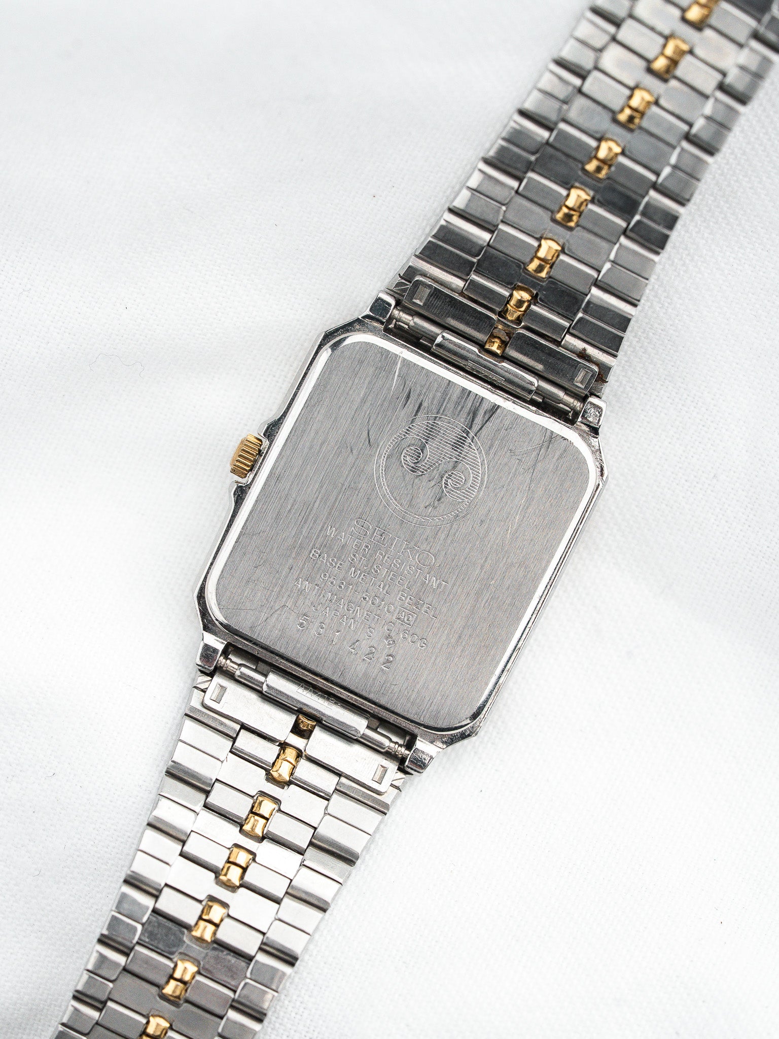 Seiko vintage watch with two-tone steel and gold bracelet, rectangular case back view