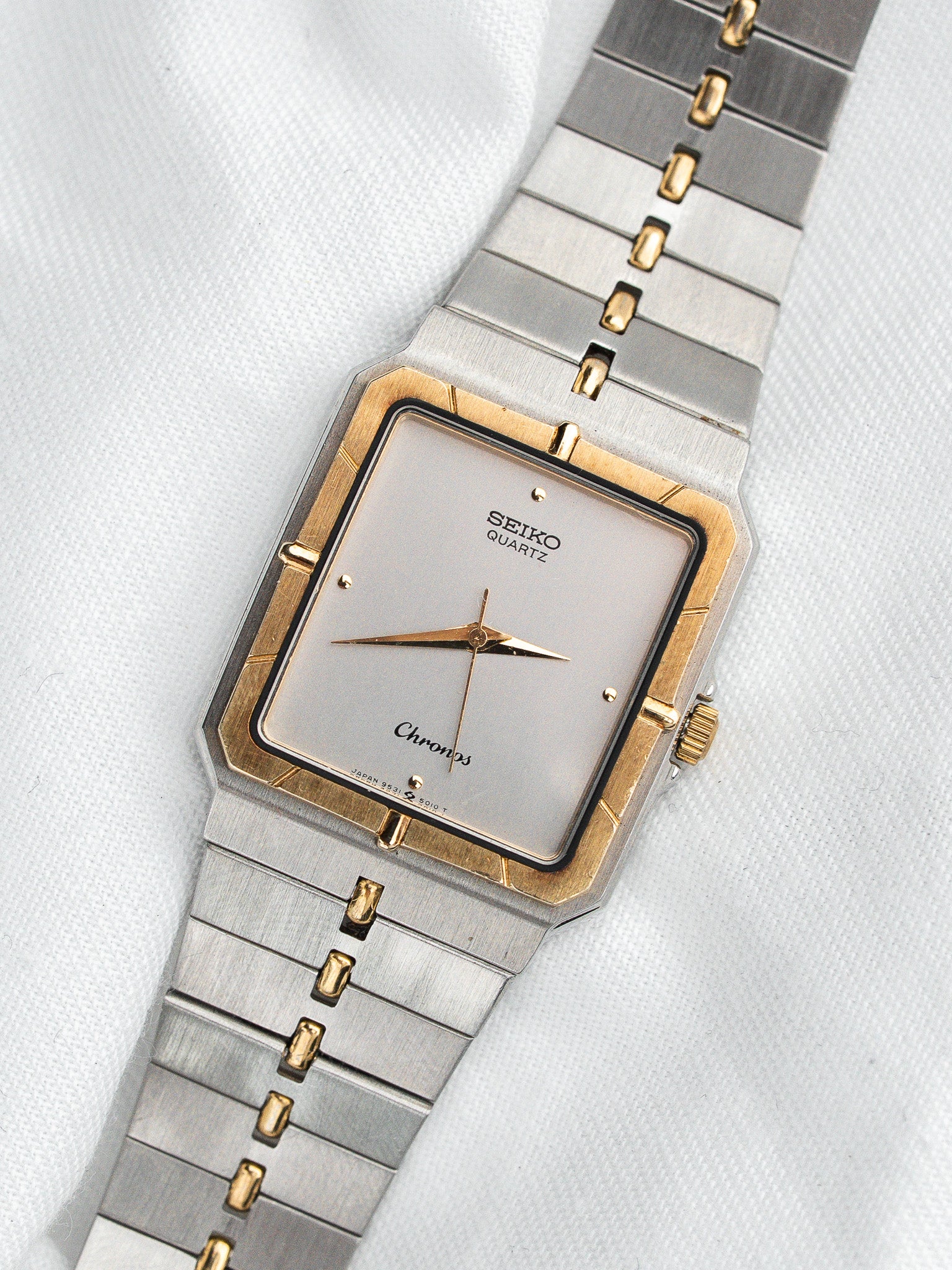Seiko Chronos vintage watch with gold accents and silver dial on white fabric