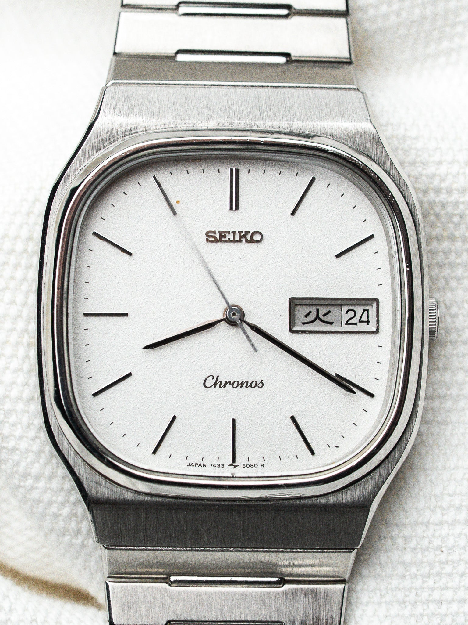 Seiko Chronos vintage watch with silver dial, day-date window, and brushed steel case
